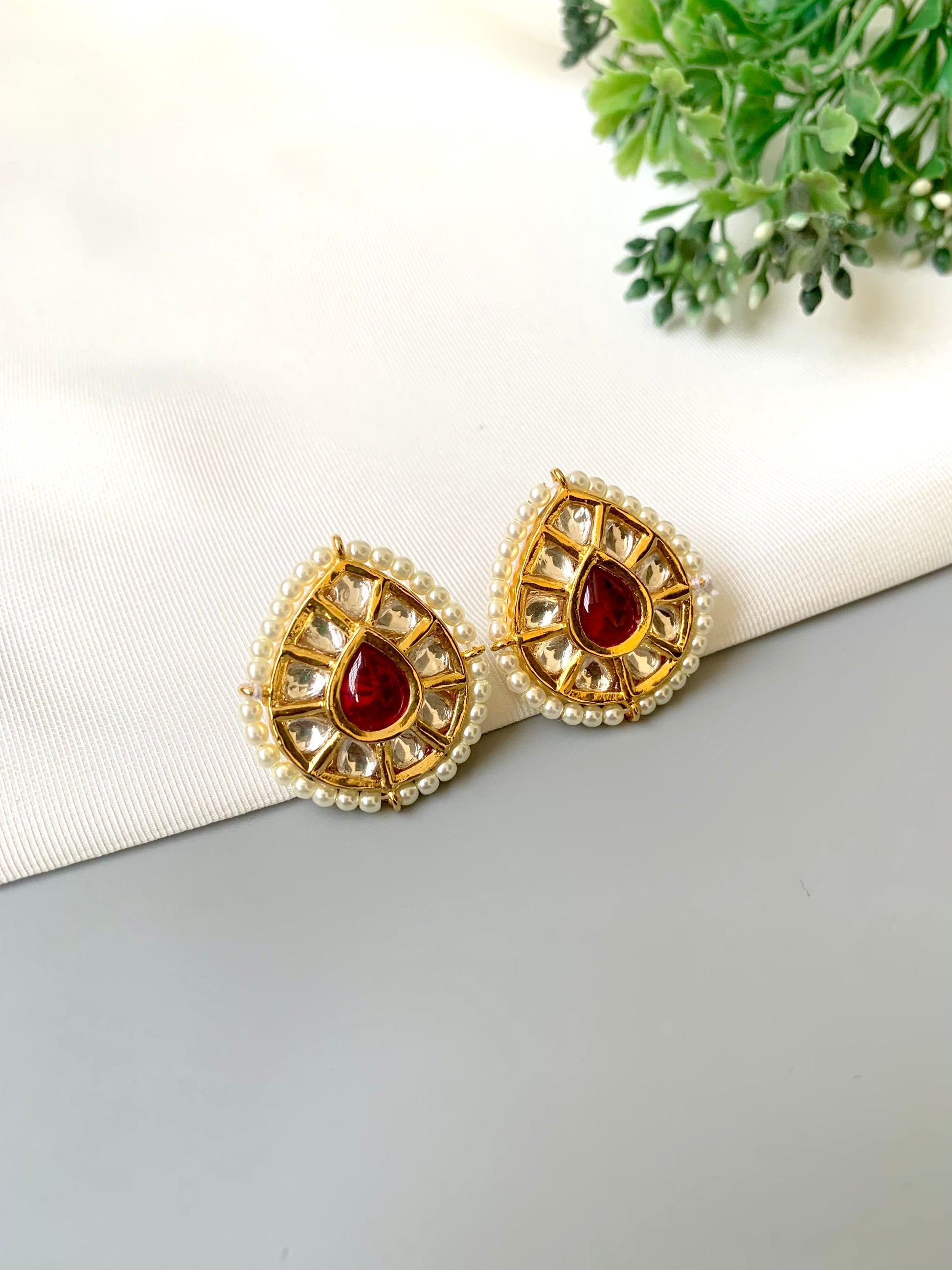 Handcrafted Mehreen Ruby Studs in 22kt gold plating with Polki Kundan, pearls, and hand-painted Meena work by Zamal Jewels.