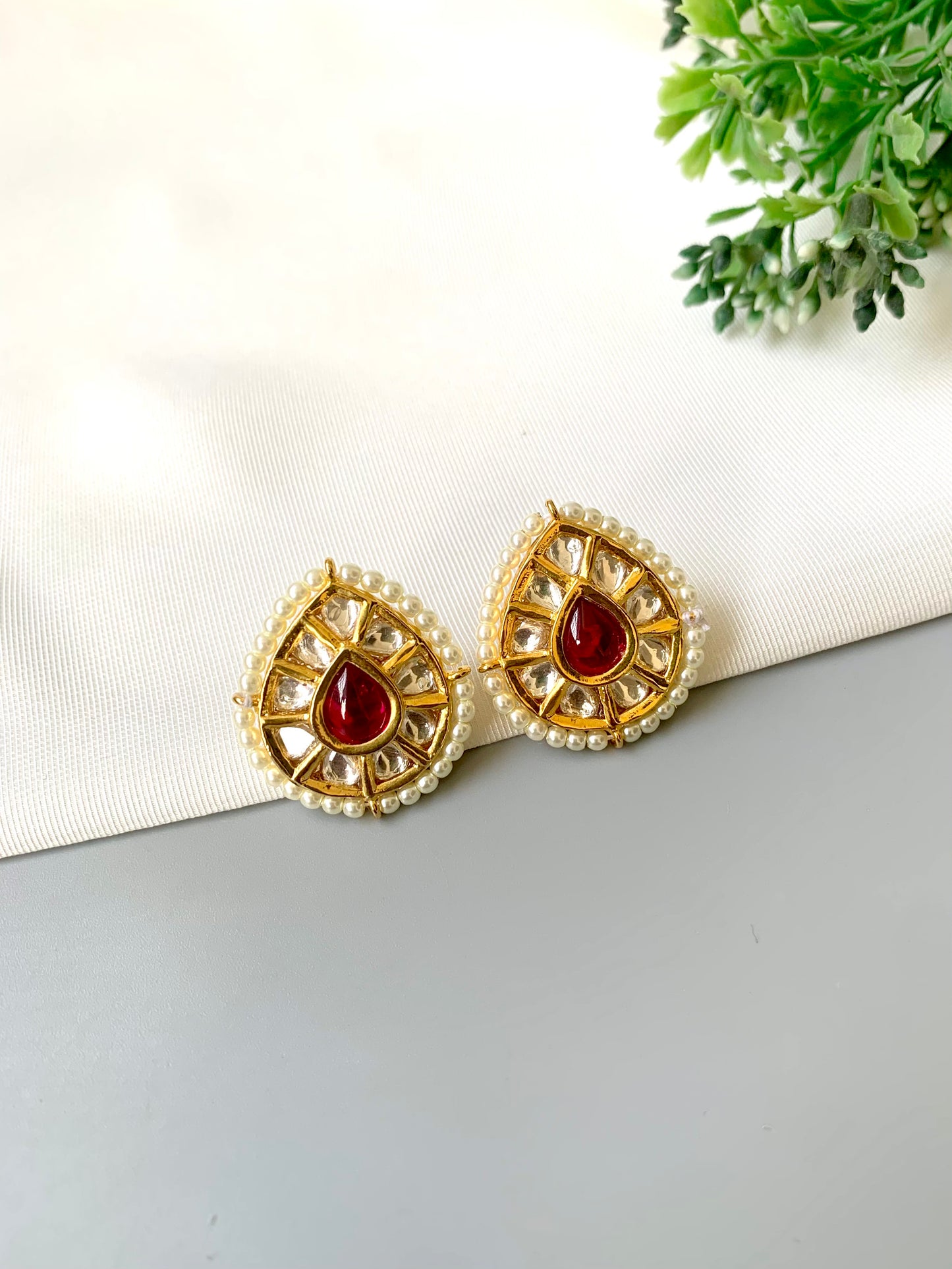 Handcrafted Mehreen Ruby Studs in 22kt gold plating with Polki Kundan, pearls, and hand-painted Meena work by Zamal Jewels.