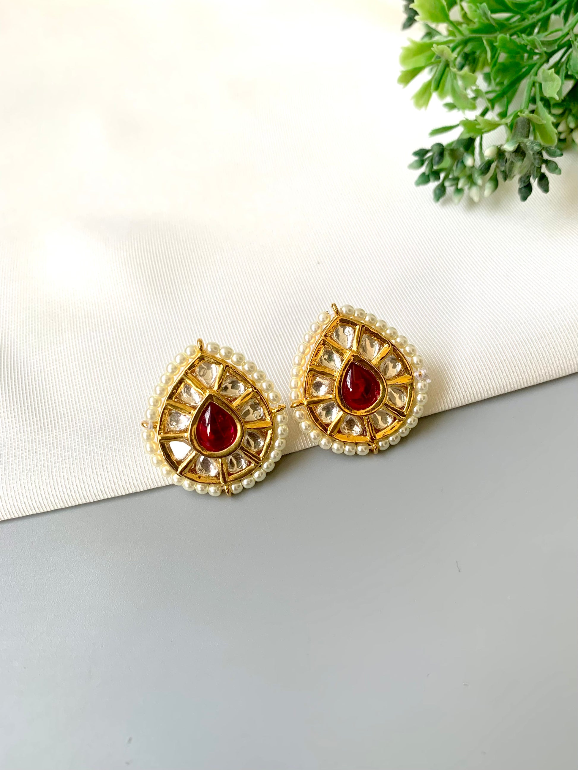 Handcrafted Mehreen Ruby Studs in 22kt gold plating with Polki Kundan, pearls, and hand-painted Meena work by Zamal Jewels.