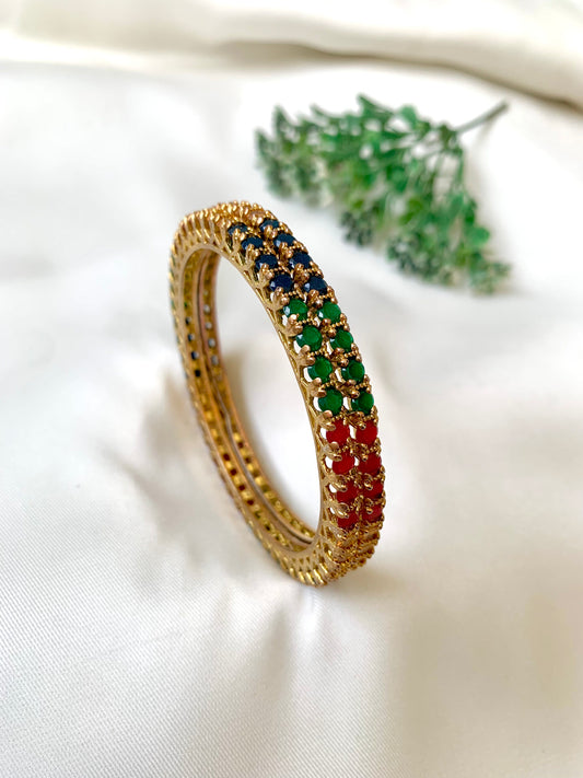 Handcrafted Neriah Bangles in 22kt gold plating with reverse Semi-Precious Ruby, Emerald, Sapphire, and Champagne stones — by Zamal Jewels.