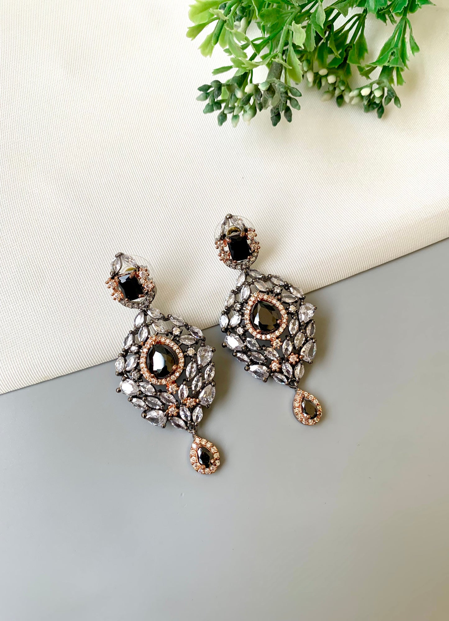 Handcrafted Noir Luxe Onyx Earrings in 22kt rose gold and rhodium plating with oxidized finish, American Diamonds, and Onyx stones by Zamal Jewels.