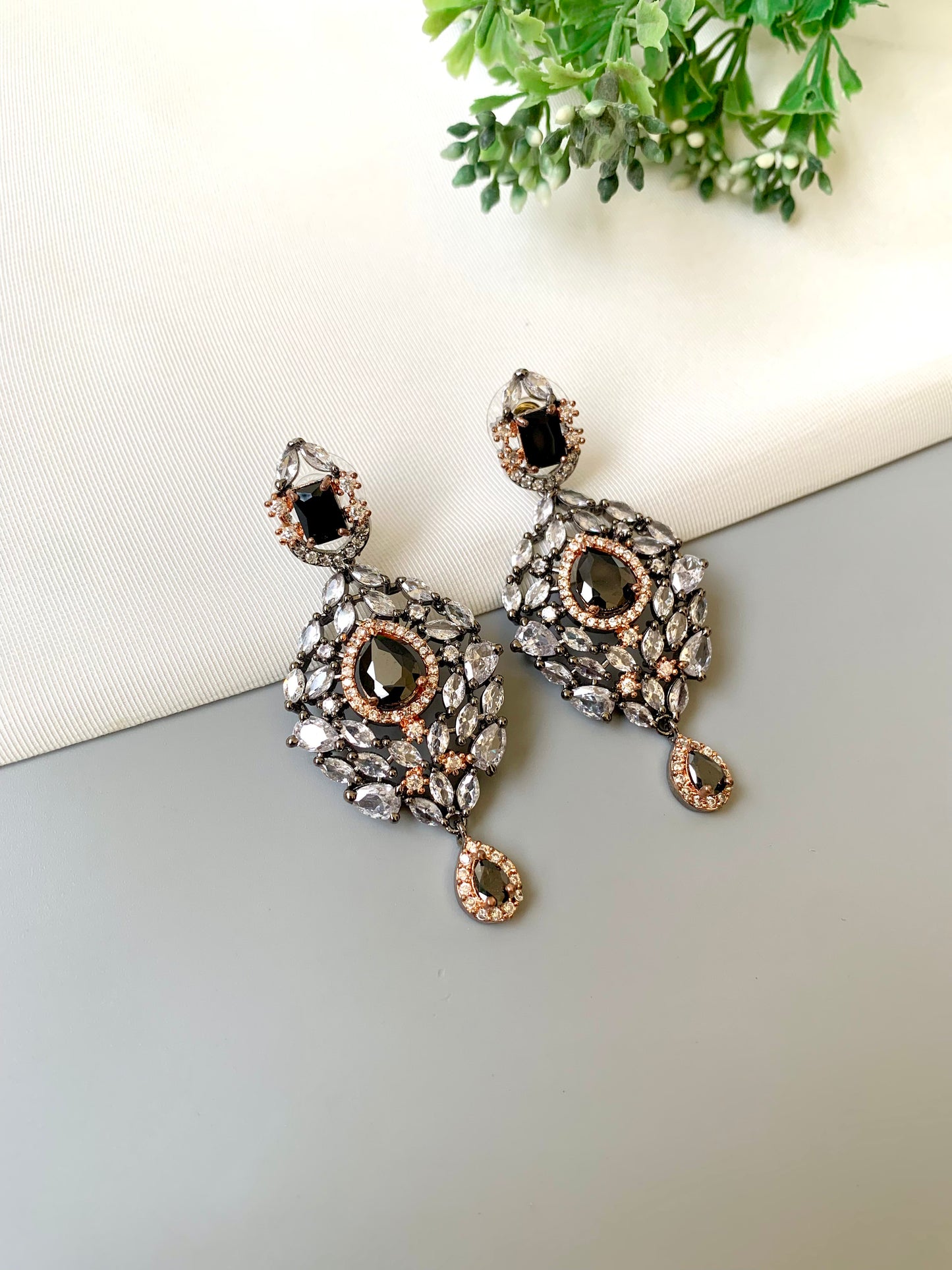 Handcrafted Noir Luxe Onyx Earrings in 22kt rose gold and rhodium plating with oxidized finish, American Diamonds, and Onyx stones by Zamal Jewels.