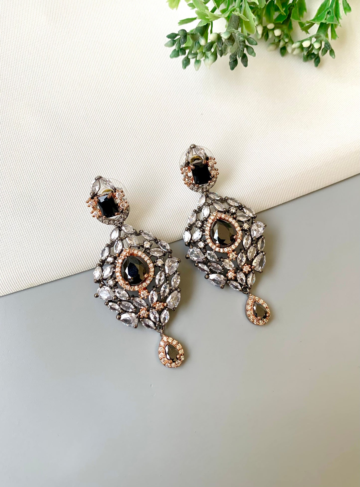 Handcrafted Noir Luxe Onyx Earrings in 22kt rose gold and rhodium plating with oxidized finish, American Diamonds, and Onyx stones by Zamal Jewels.
