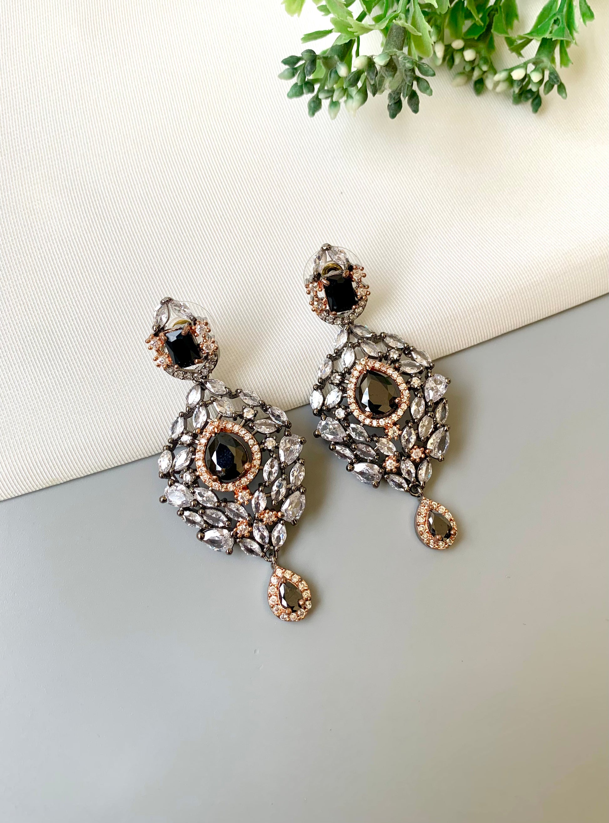 Handcrafted Noir Luxe Onyx Earrings in 22kt rose gold and rhodium plating with oxidized finish, American Diamonds, and Onyx stones by Zamal Jewels.