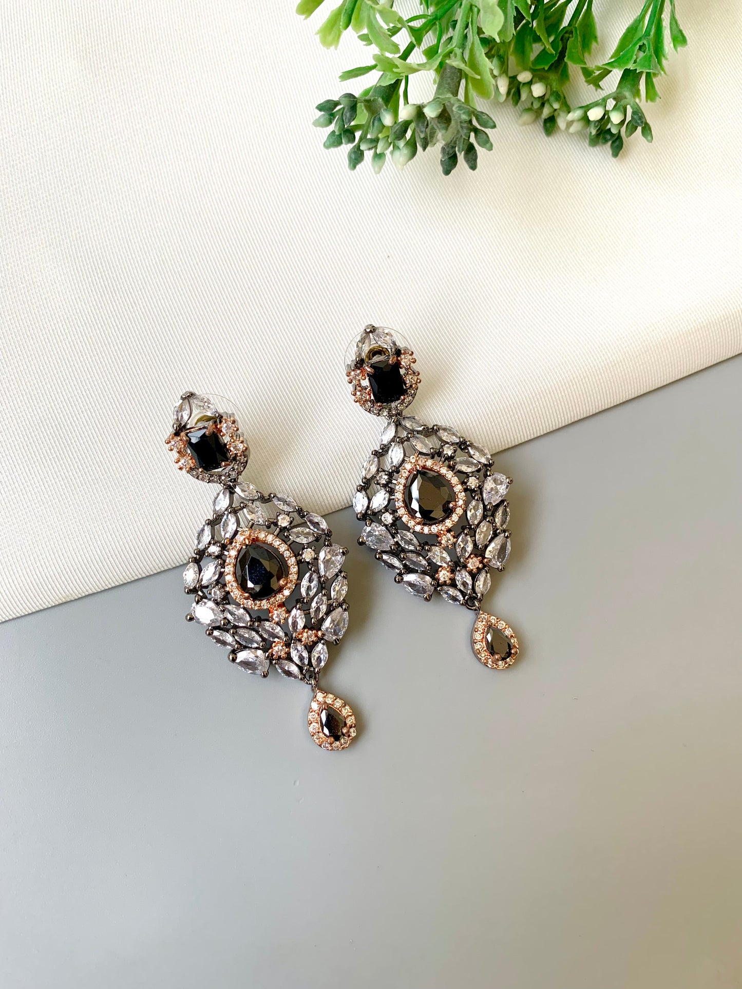 Handcrafted Noir Luxe Onyx Earrings in 22kt rose gold and rhodium plating with oxidized finish, American Diamonds, and Onyx stones by Zamal Jewels.