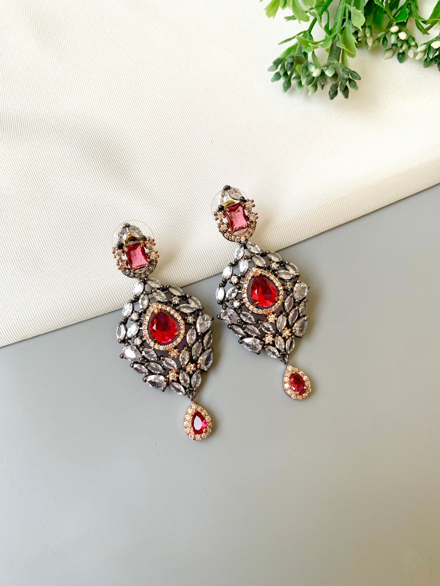 Handcrafted Noir Luxe Ruby Earrings in oxidized rose gold and rhodium plating with American Diamonds and semi-precious Ruby stones by Zamal Jewels.