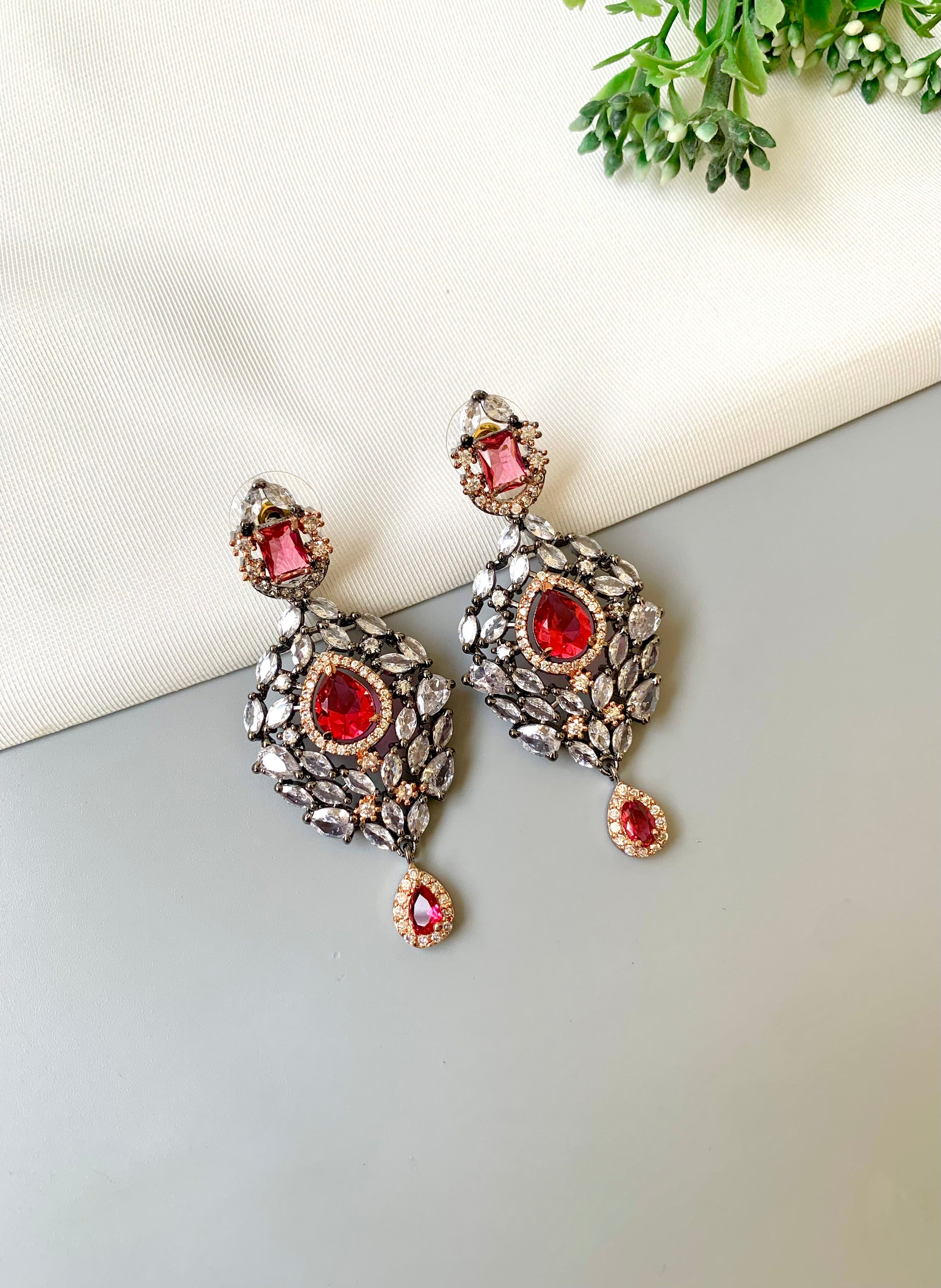 Handcrafted Noir Luxe Ruby Earrings in oxidized rose gold and rhodium plating with American Diamonds and semi-precious Ruby stones by Zamal Jewels.