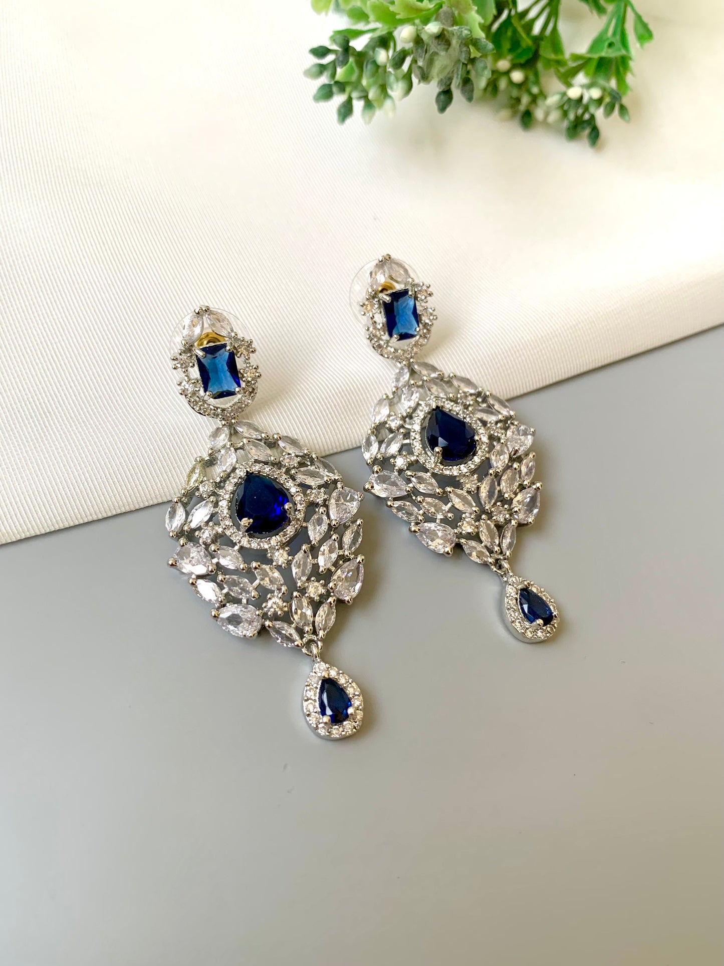 Handcrafted Noir Luxe Sapphire Earrings in rhodium plating with American Diamonds and semi-precious Sapphire stones by Zamal Jewels.