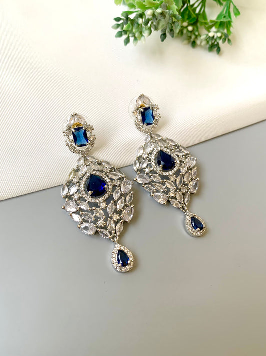 Handcrafted Noir Luxe Sapphire Earrings in rhodium plating with American Diamonds and semi-precious Sapphire stones by Zamal Jewels.