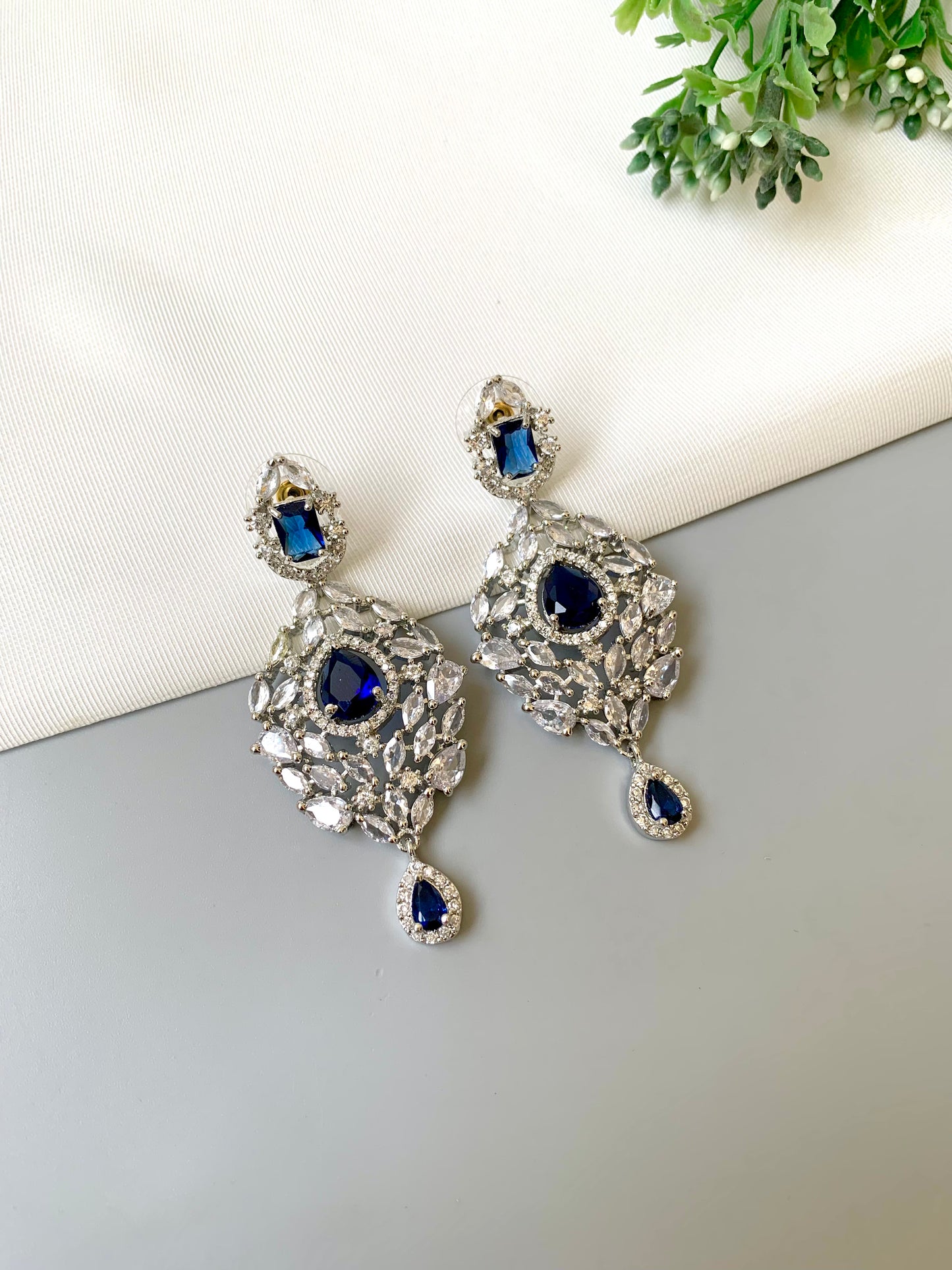 Handcrafted Noir Luxe Sapphire Earrings in rhodium plating with American Diamonds and semi-precious Sapphire stones by Zamal Jewels.