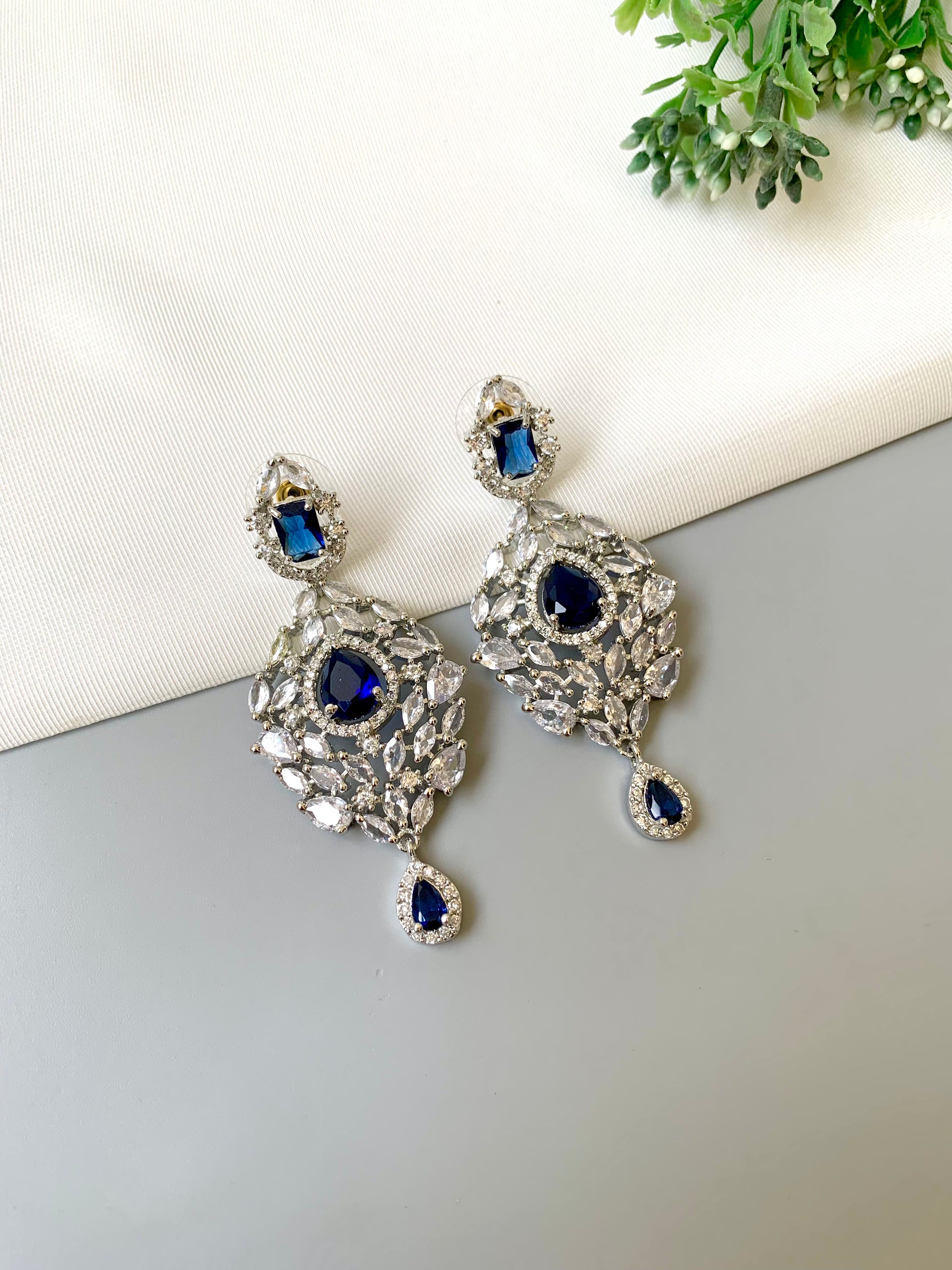 Handcrafted Noir Luxe Sapphire Earrings in rhodium plating with American Diamonds and semi-precious Sapphire stones by Zamal Jewels.