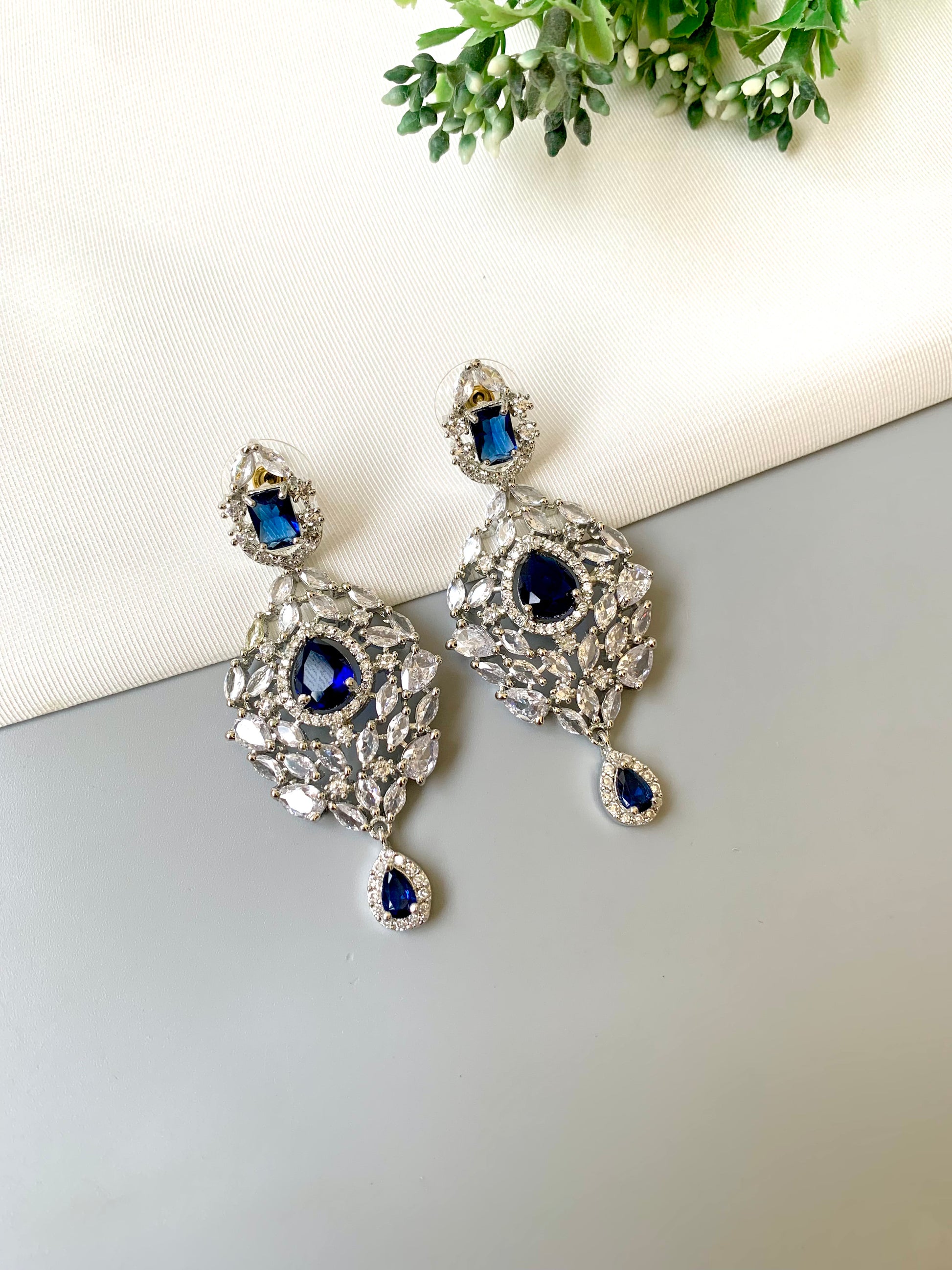 Handcrafted Noir Luxe Sapphire Earrings in rhodium plating with American Diamonds and semi-precious Sapphire stones by Zamal Jewels.