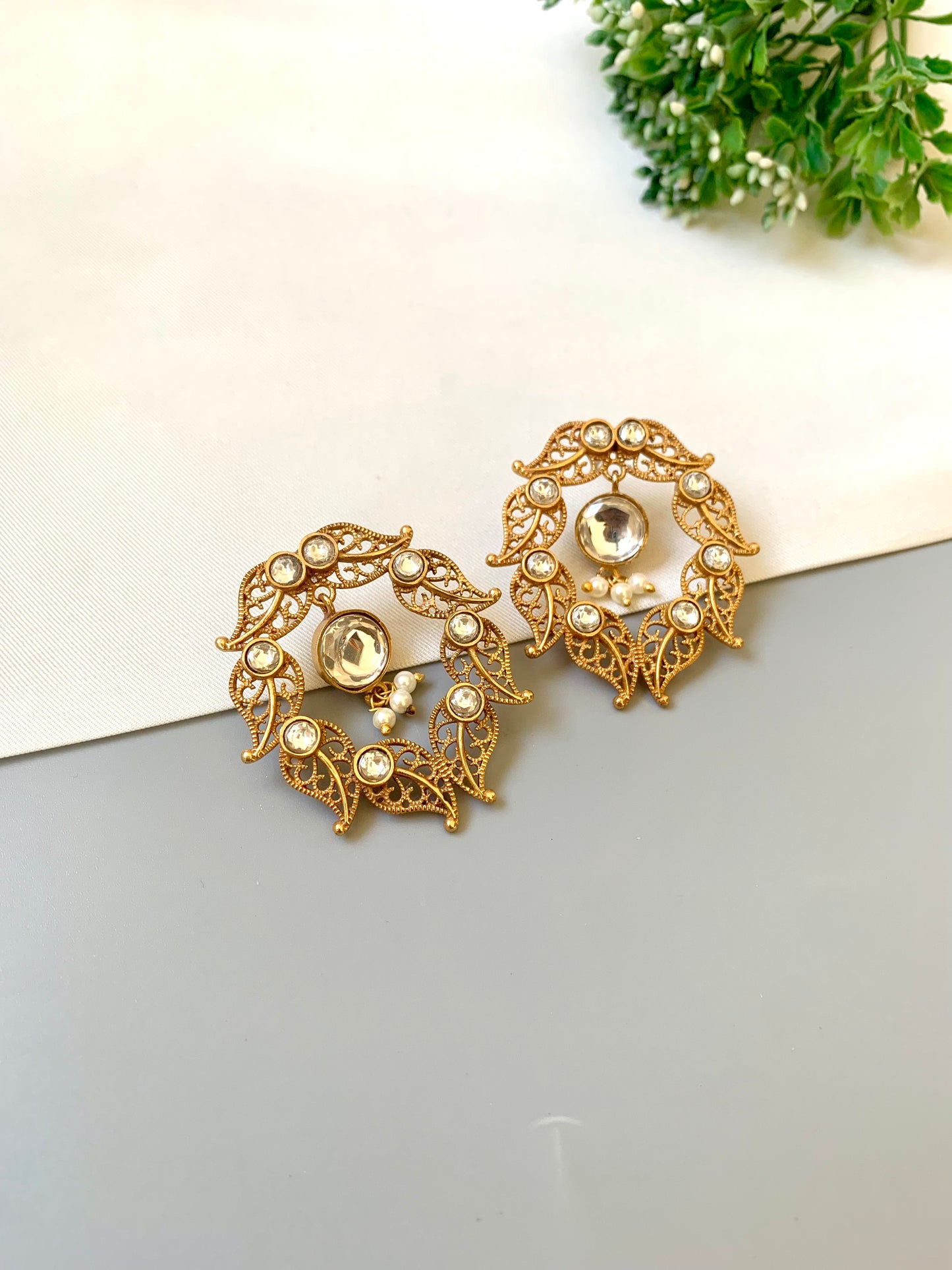 Handcrafted 22kt gold plated designer earrings with Polki Kundan stones and semi precious pearl detailing