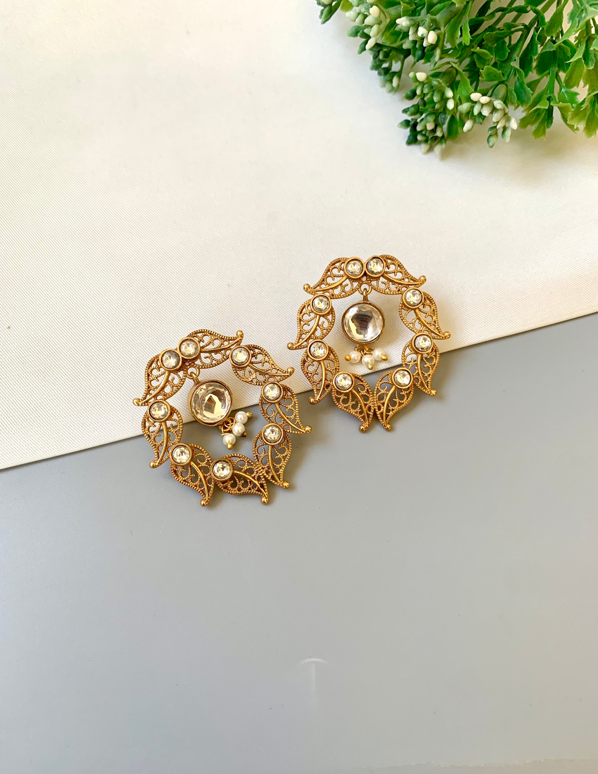 Handcrafted 22kt gold plated designer earrings with Polki Kundan stones and semi precious pearl detailing