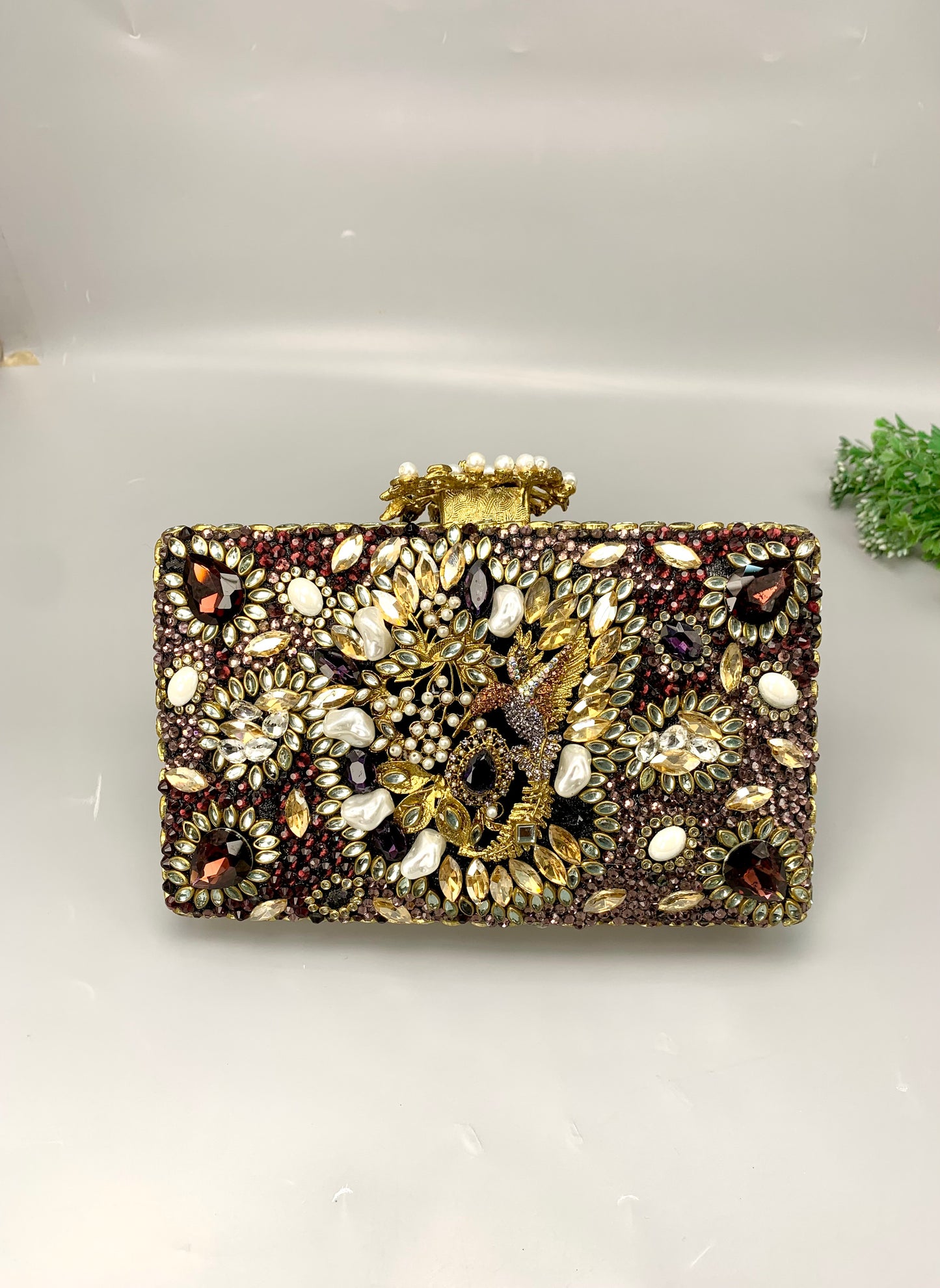 Zareen handcrafted gold plated clutch with kundan, American diamonds, pearls and gemstone embellishments