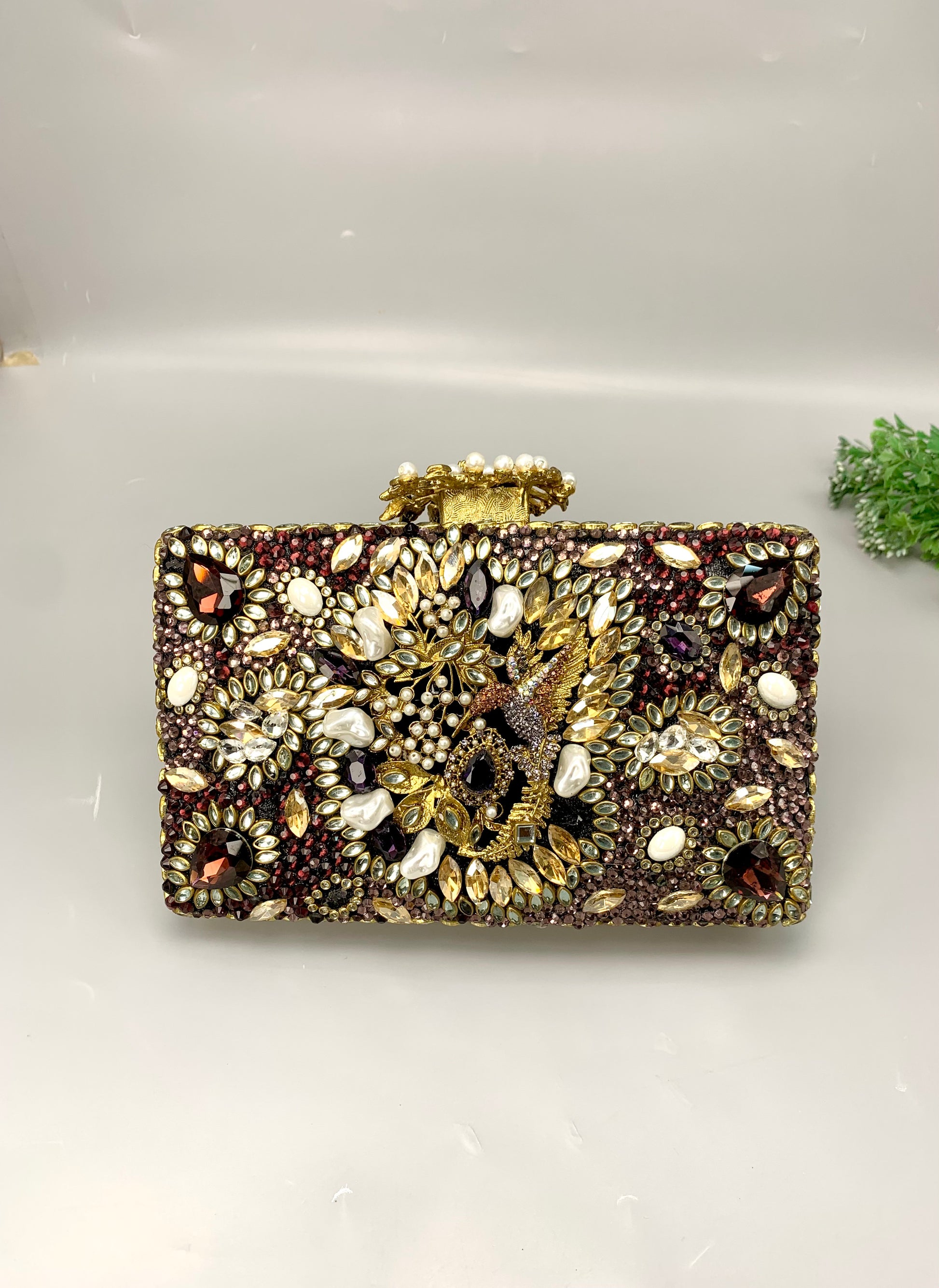 Zareen handcrafted gold plated clutch with kundan, American diamonds, pearls and gemstone embellishments
