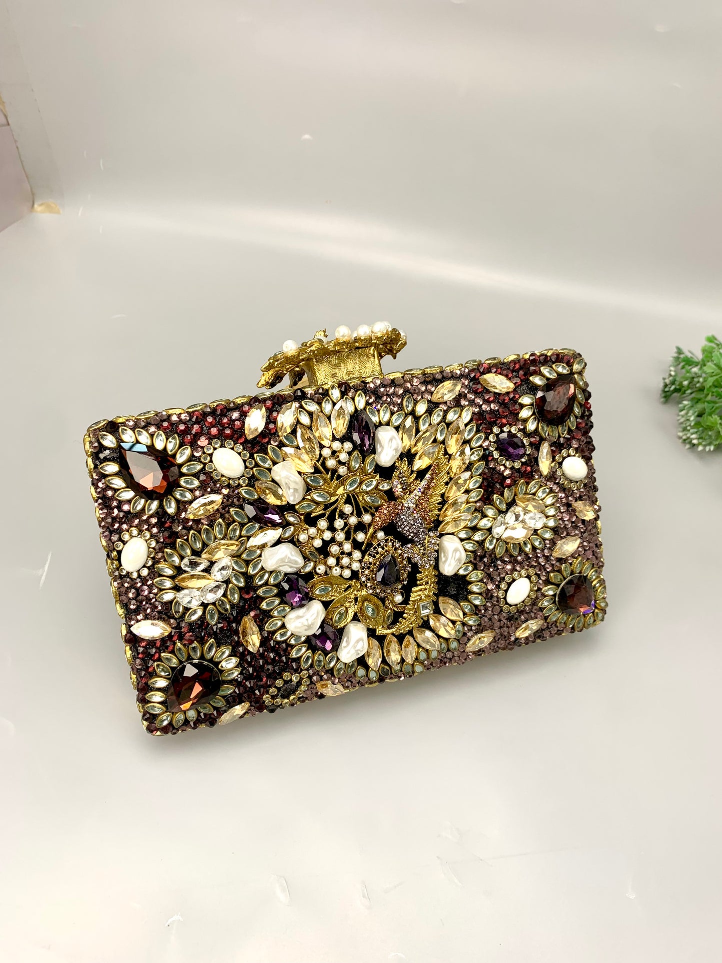Zareen handcrafted gold plated clutch with kundan, American diamonds, pearls and gemstone embellishments