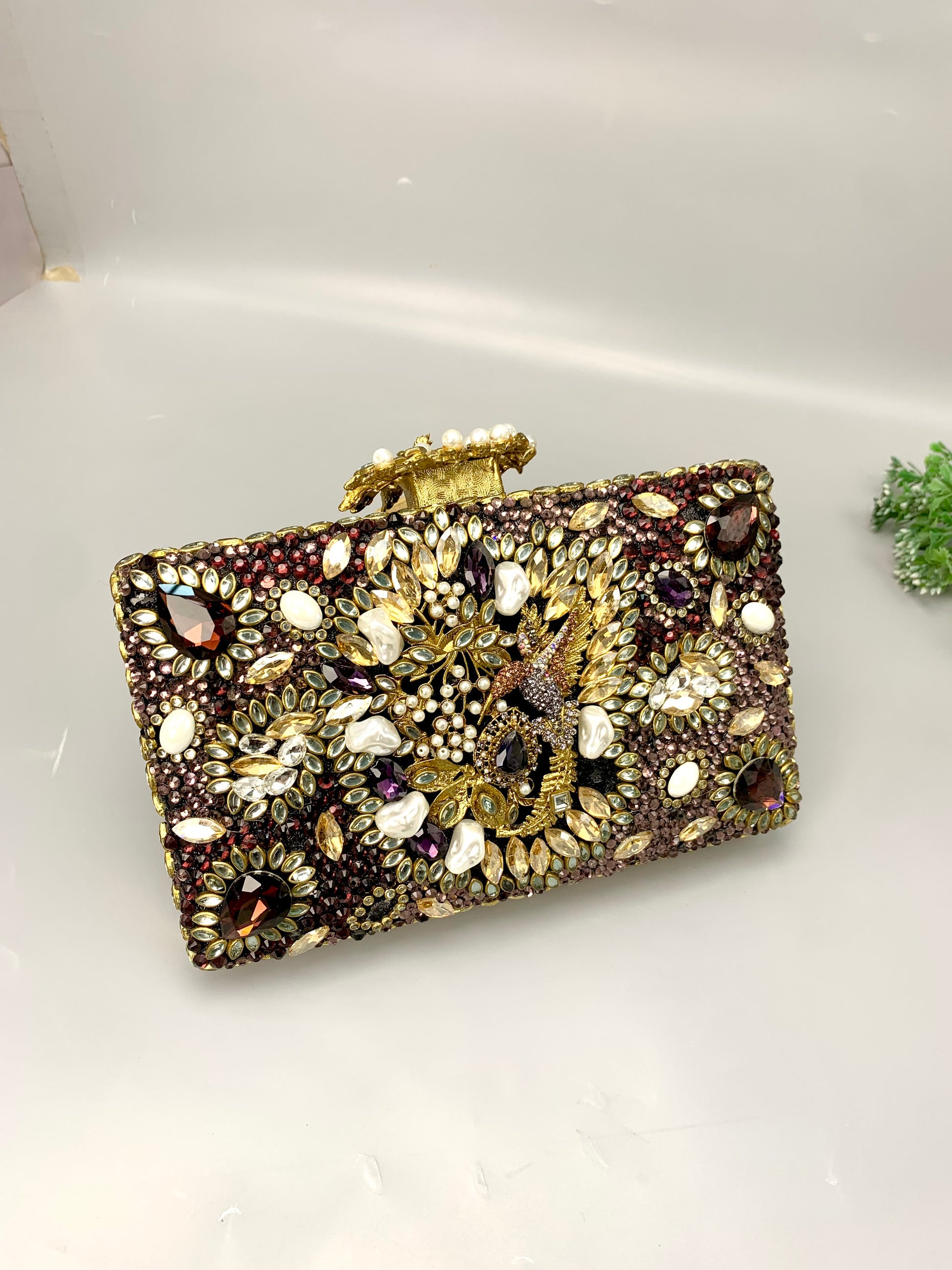 Zareen handcrafted gold plated clutch with kundan, American diamonds, pearls and gemstone embellishments