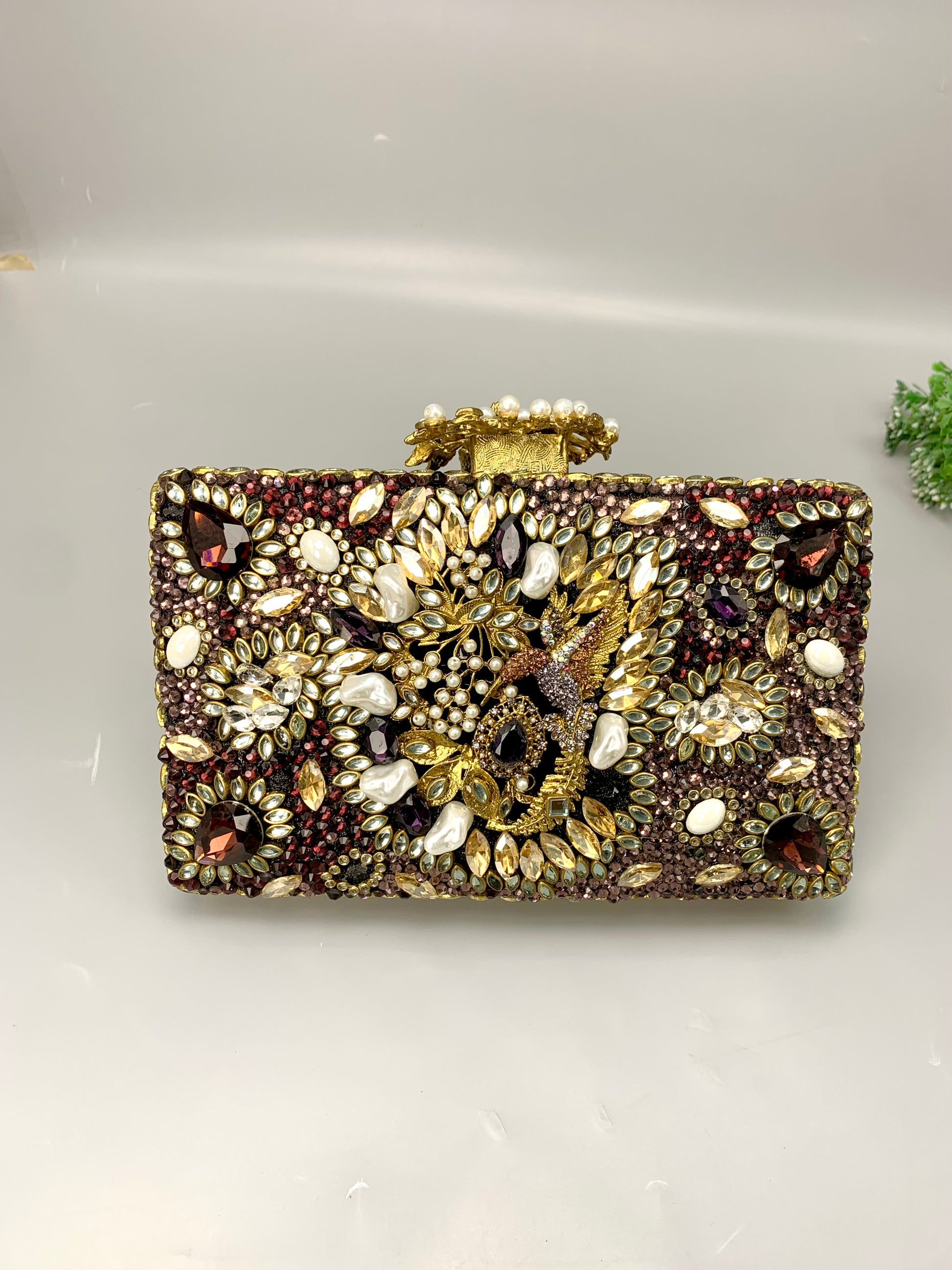 Zareen handcrafted gold plated clutch with kundan, American diamonds, pearls and gemstone embellishments