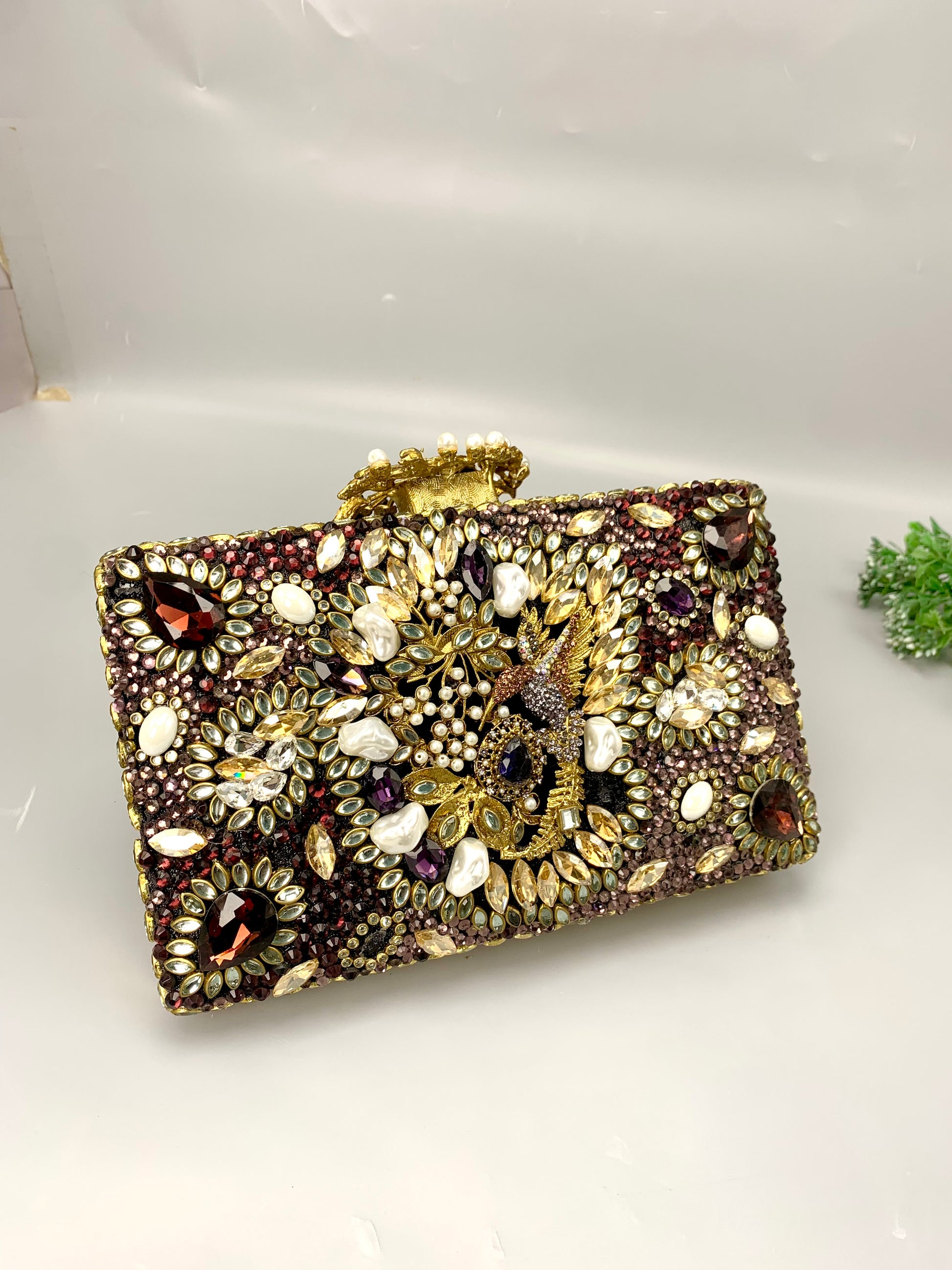 Zareen handcrafted gold plated clutch with kundan, American diamonds, pearls and gemstone embellishments