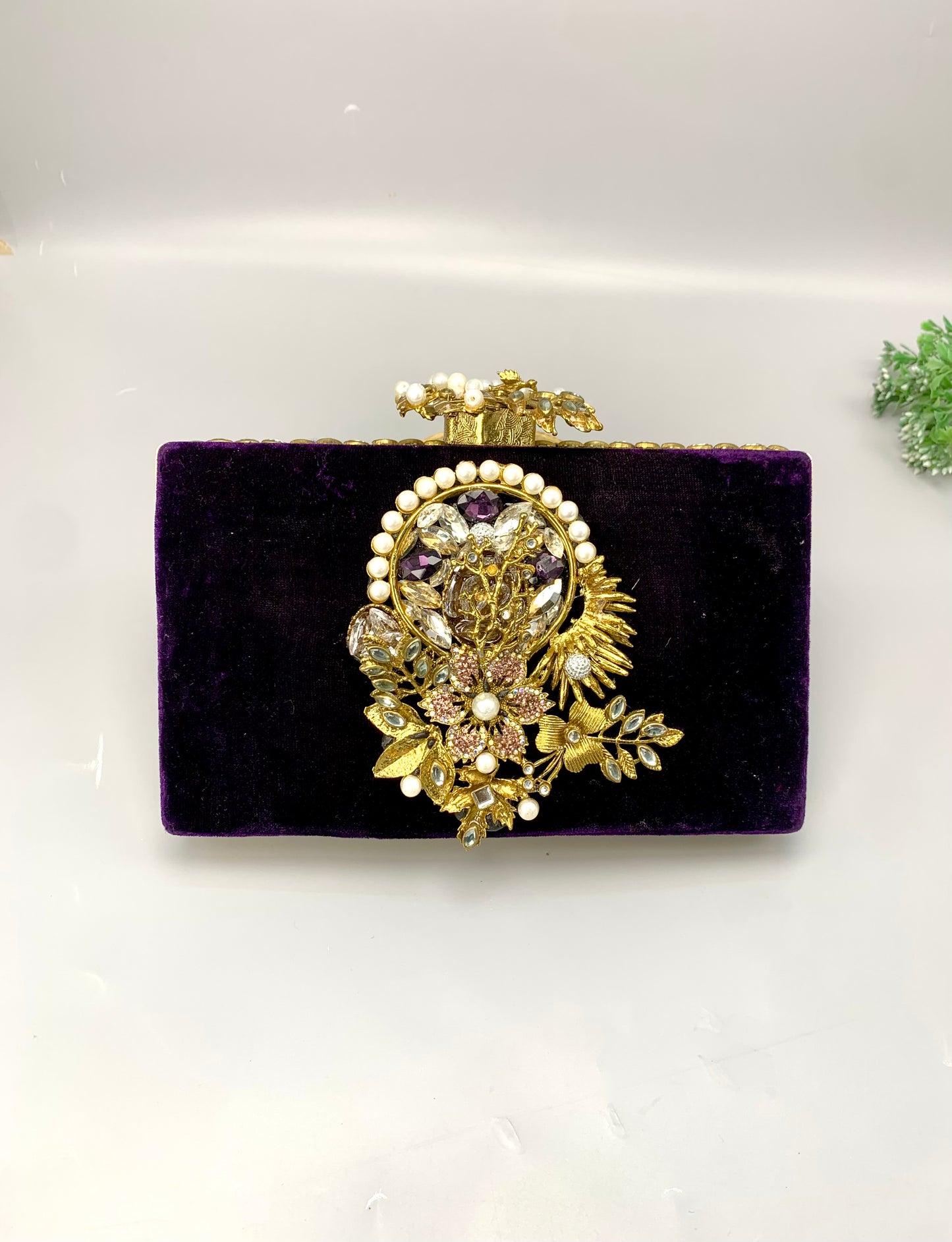 Zareen handcrafted gold plated clutch with kundan, American diamonds, pearls and gemstone embellishments