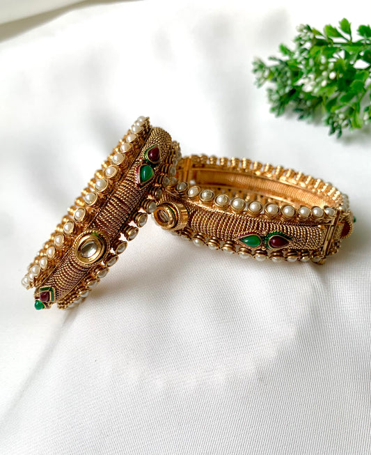 Pair of handcrafted 22kt gold plated openable screw bangles with Kundan, semi-precious pearls, ruby, and emerald stones
