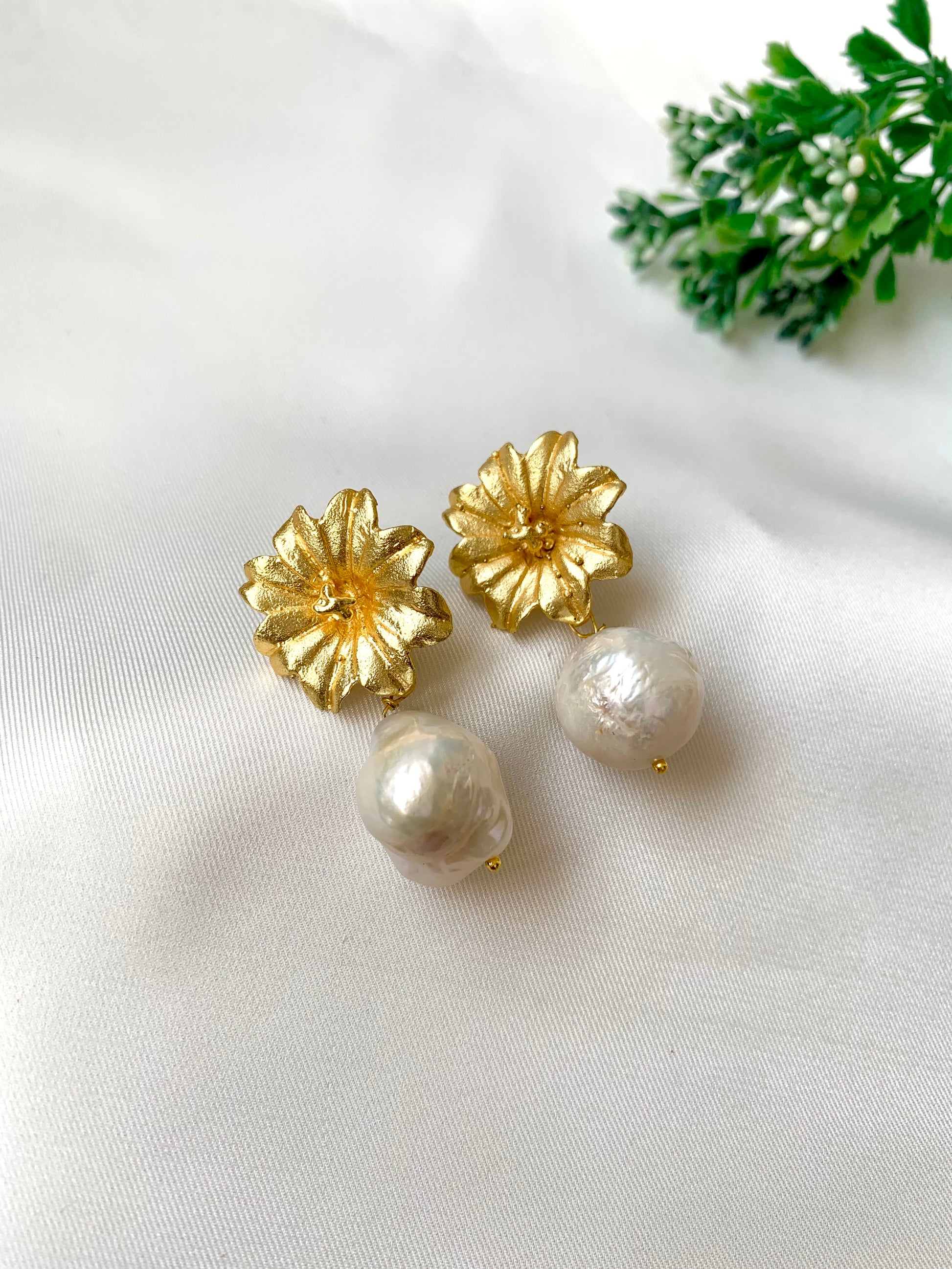 Hand crafted Zarqa studs in 22kt gold plating with foil finish featuring real semi-precious Baroque pearls