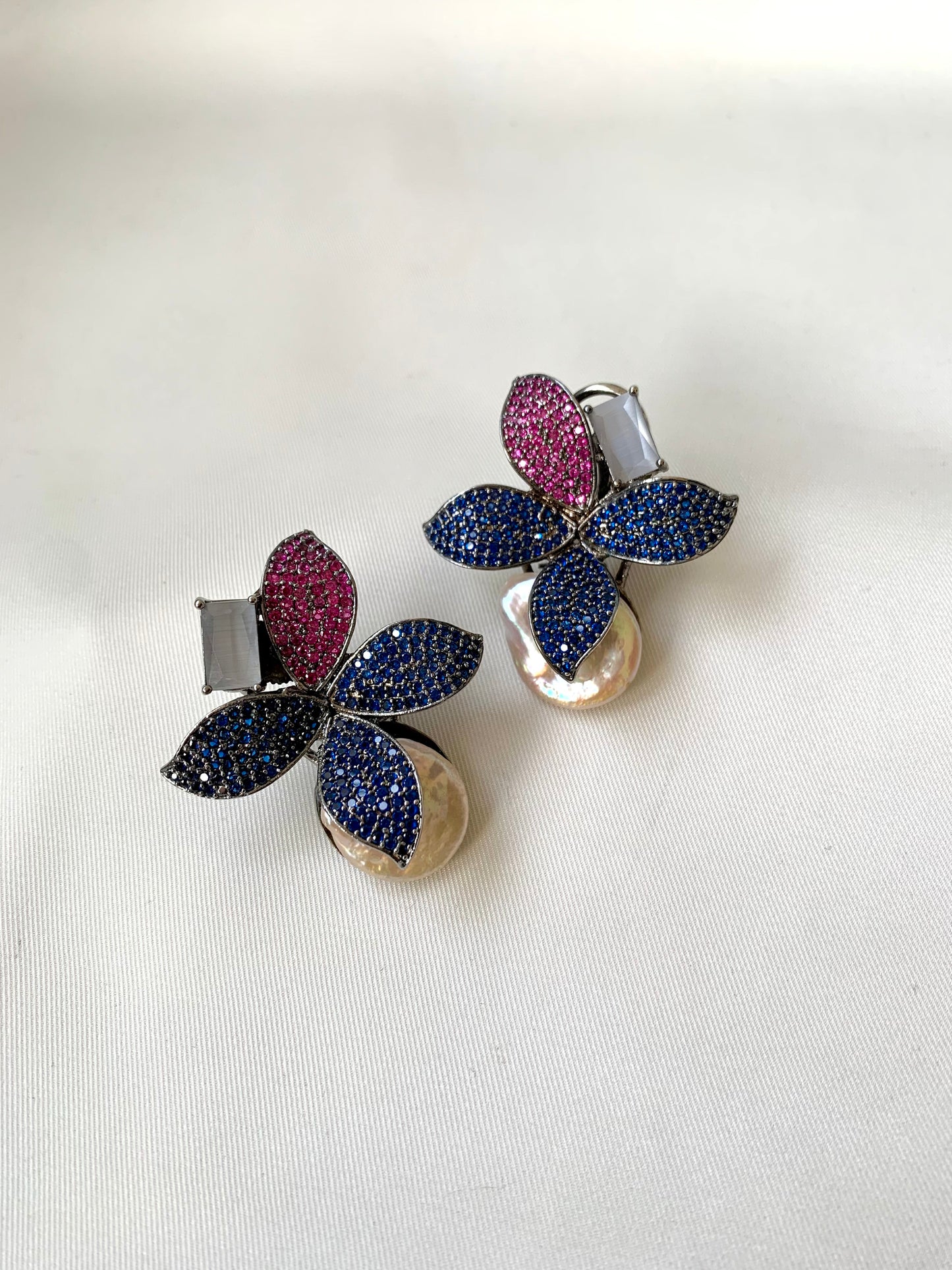 Hand crafted Zarqa designer earrings in rhodium plating featuring real baroque pearls, semi-precious onyx and ruby sapphire Swarovski gemstones