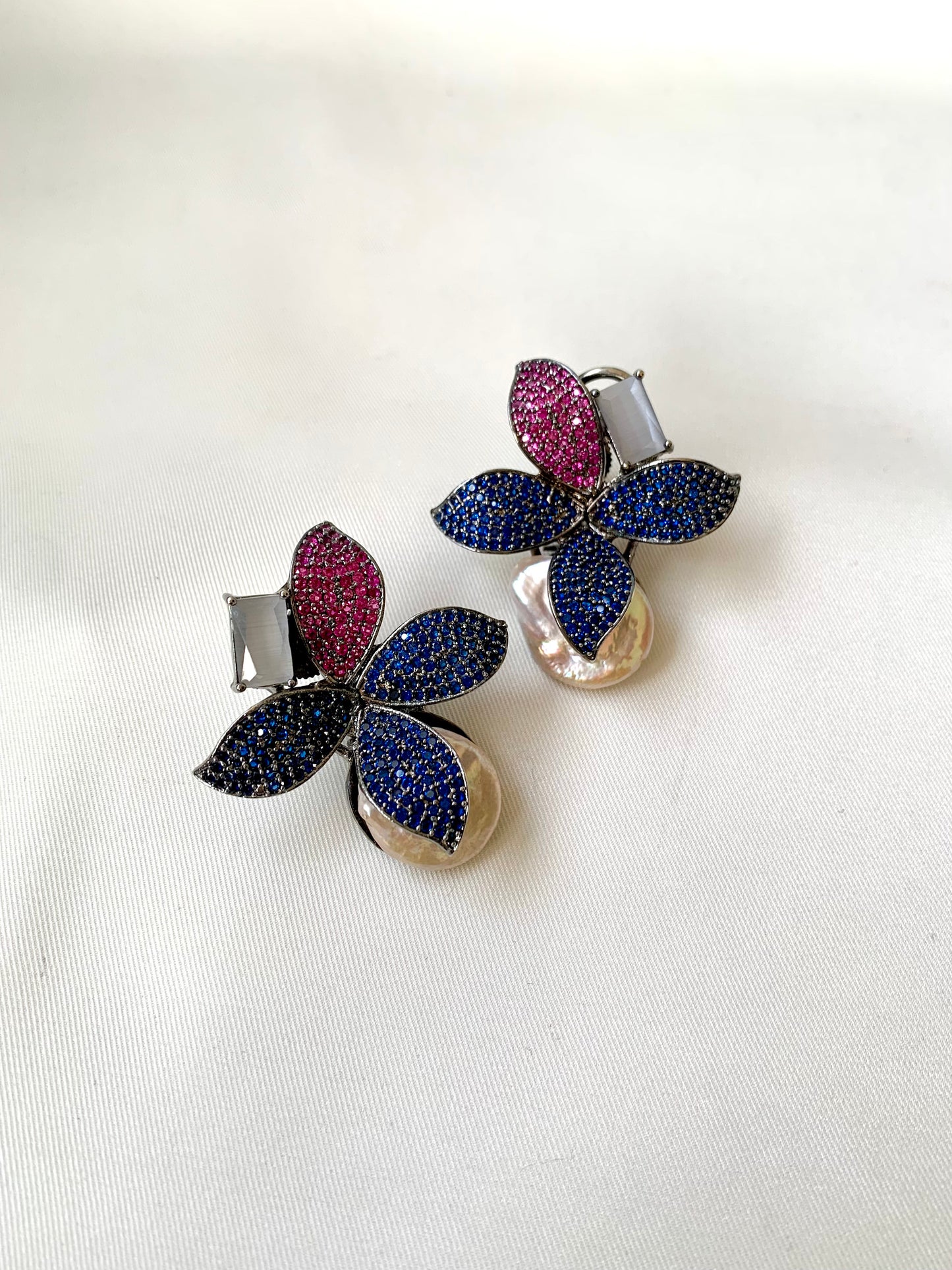 Hand crafted Zarqa designer earrings in rhodium plating featuring real baroque pearls, semi-precious onyx and ruby sapphire Swarovski gemstones