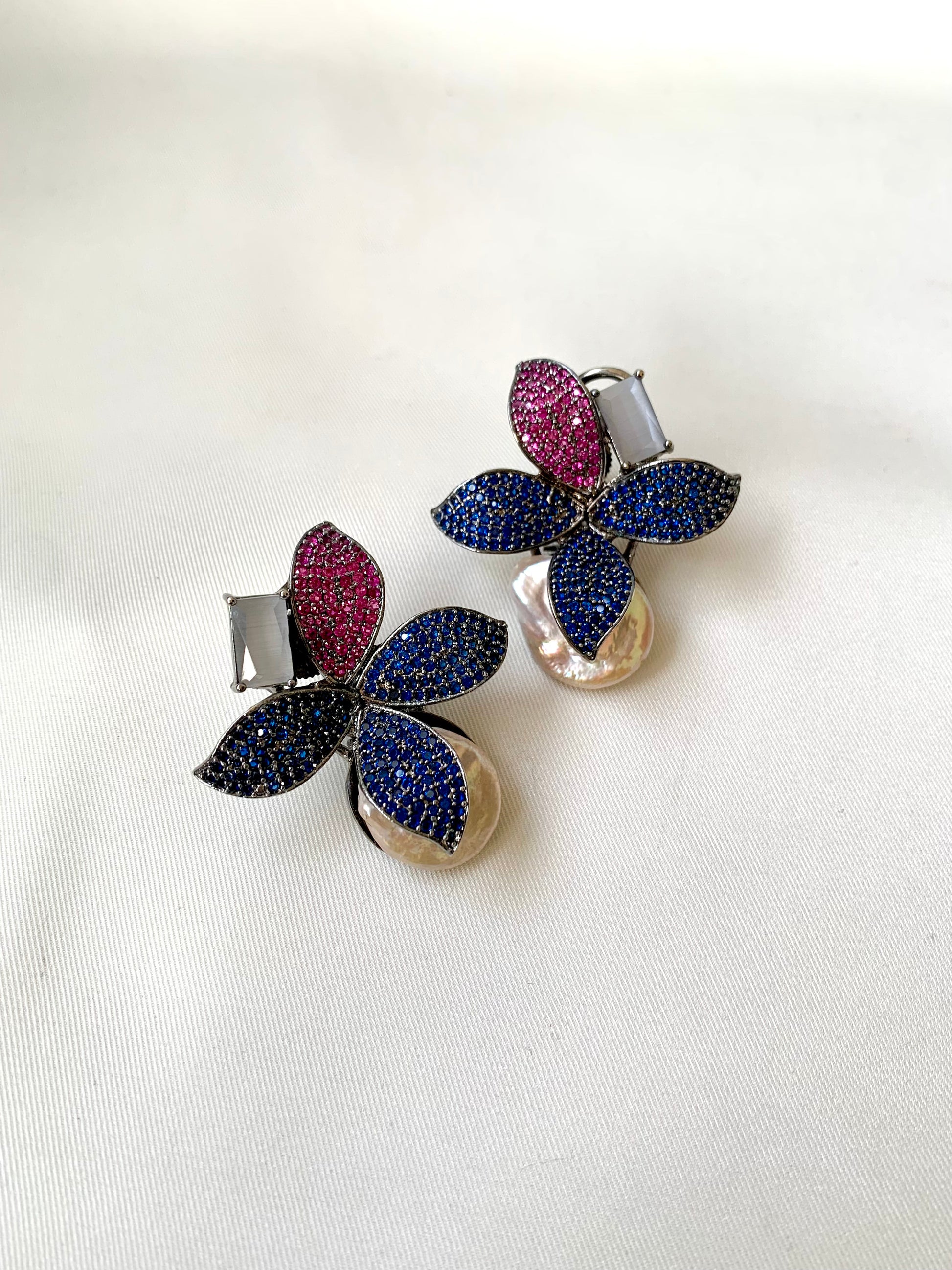 Hand crafted Zarqa designer earrings in rhodium plating featuring real baroque pearls, semi-precious onyx and ruby sapphire Swarovski gemstones