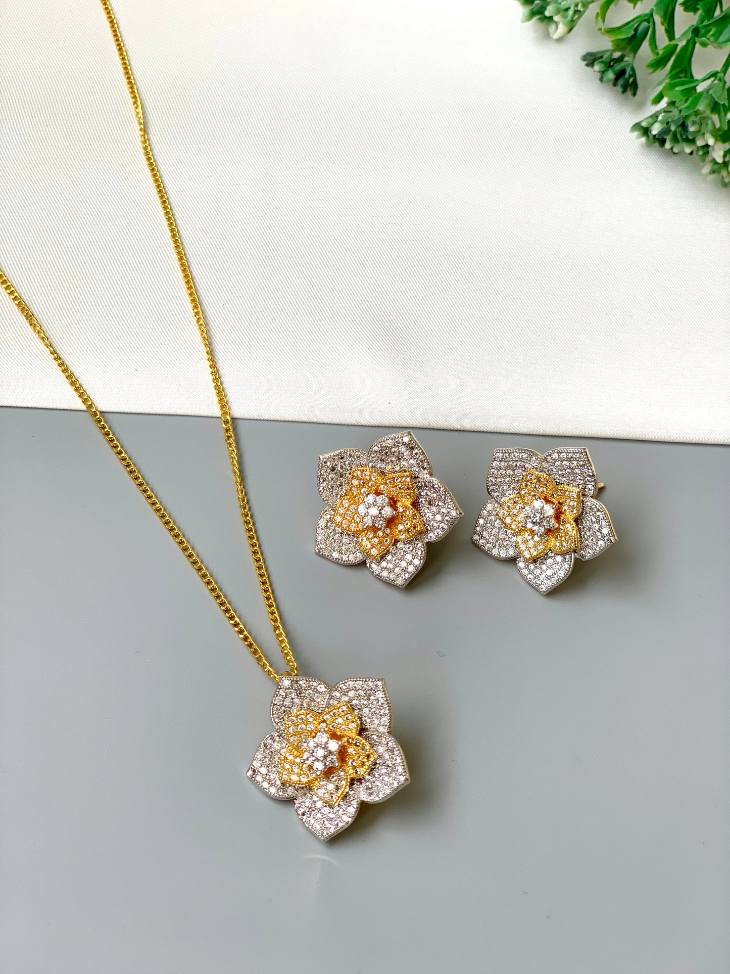 Zarwah floral pendant set in gold and rhodium plating with American diamonds and matching earrings