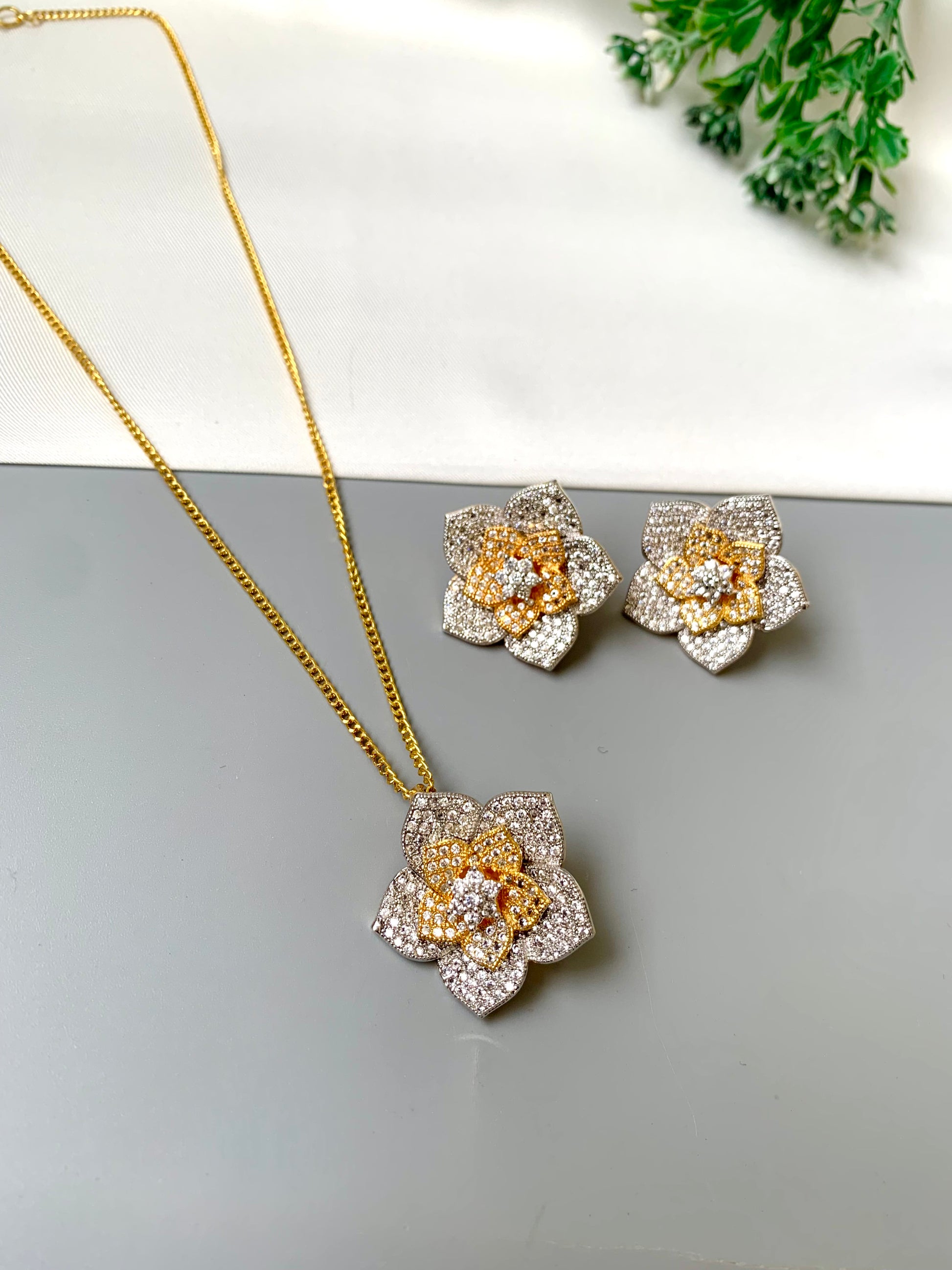 Zarwah floral pendant set in gold and rhodium plating with American diamonds and matching earrings