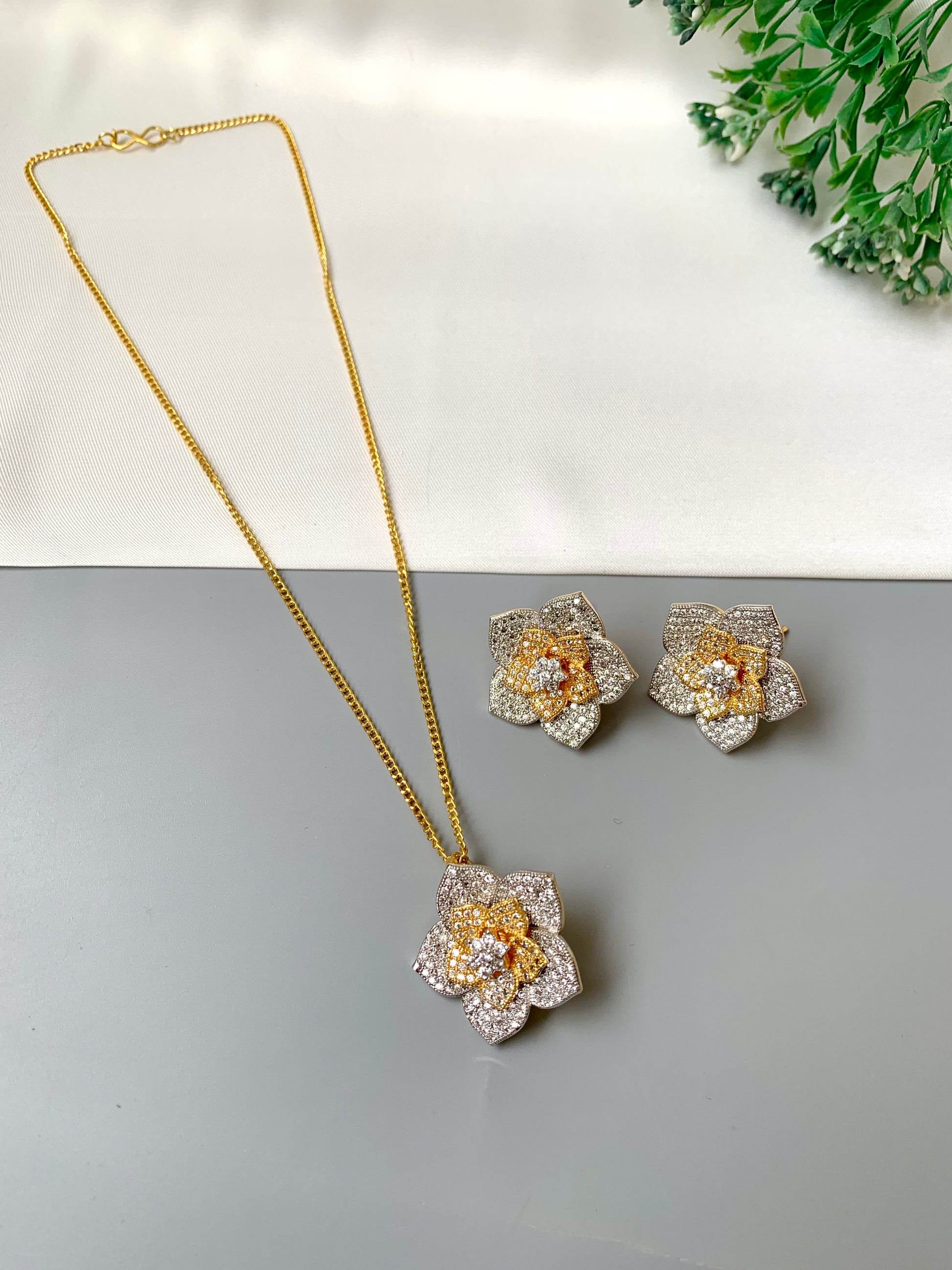 Zarwah floral pendant set in gold and rhodium plating with American diamonds and matching earrings
