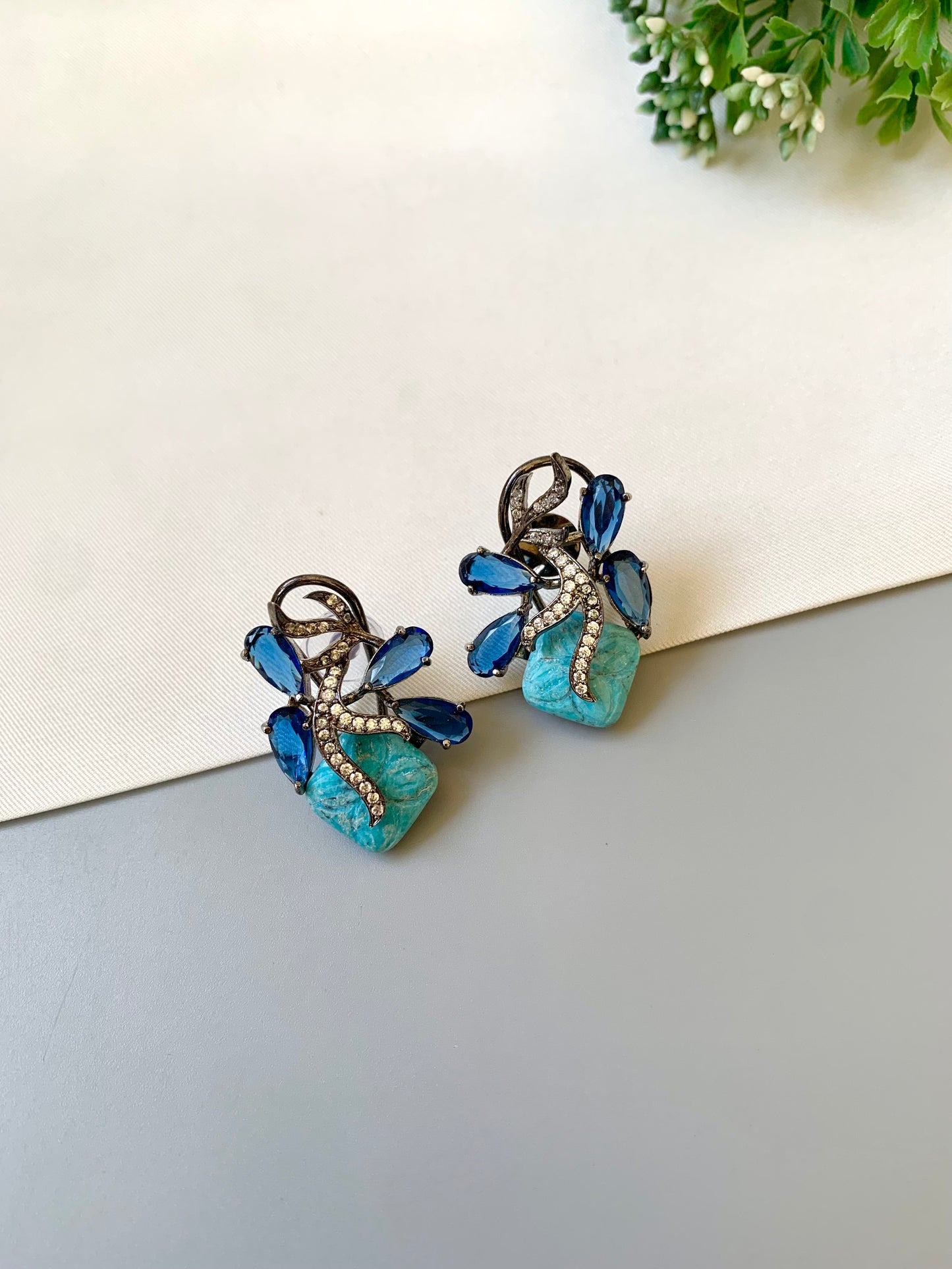 Hand crafted Zita Feroza studs in rhodium plating with oxidized polish, featuring American Diamonds, hand carved Feroza and Sapphire stones