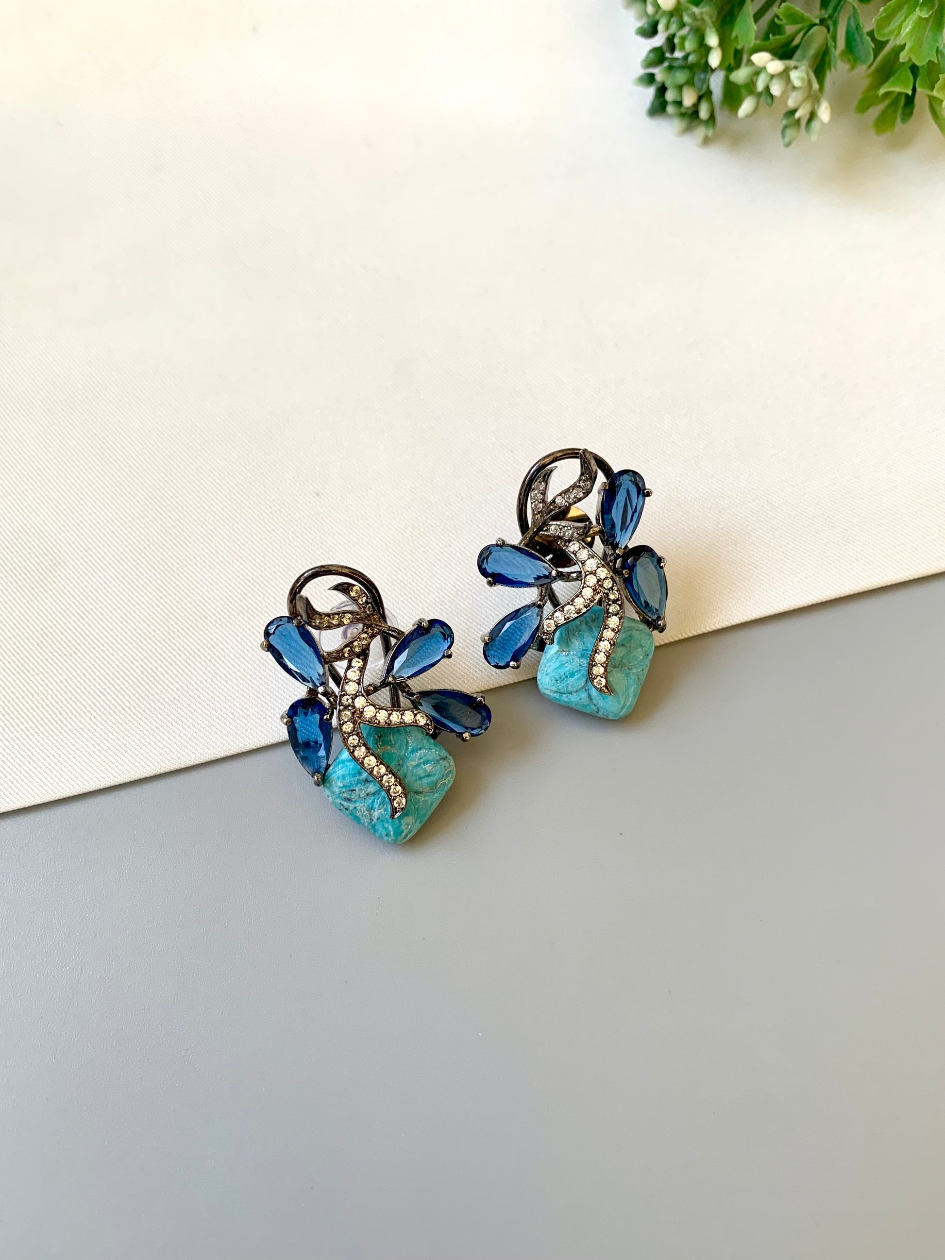 Hand crafted Zita Feroza studs in rhodium plating with oxidized polish, featuring American Diamonds, hand carved Feroza and Sapphire stones