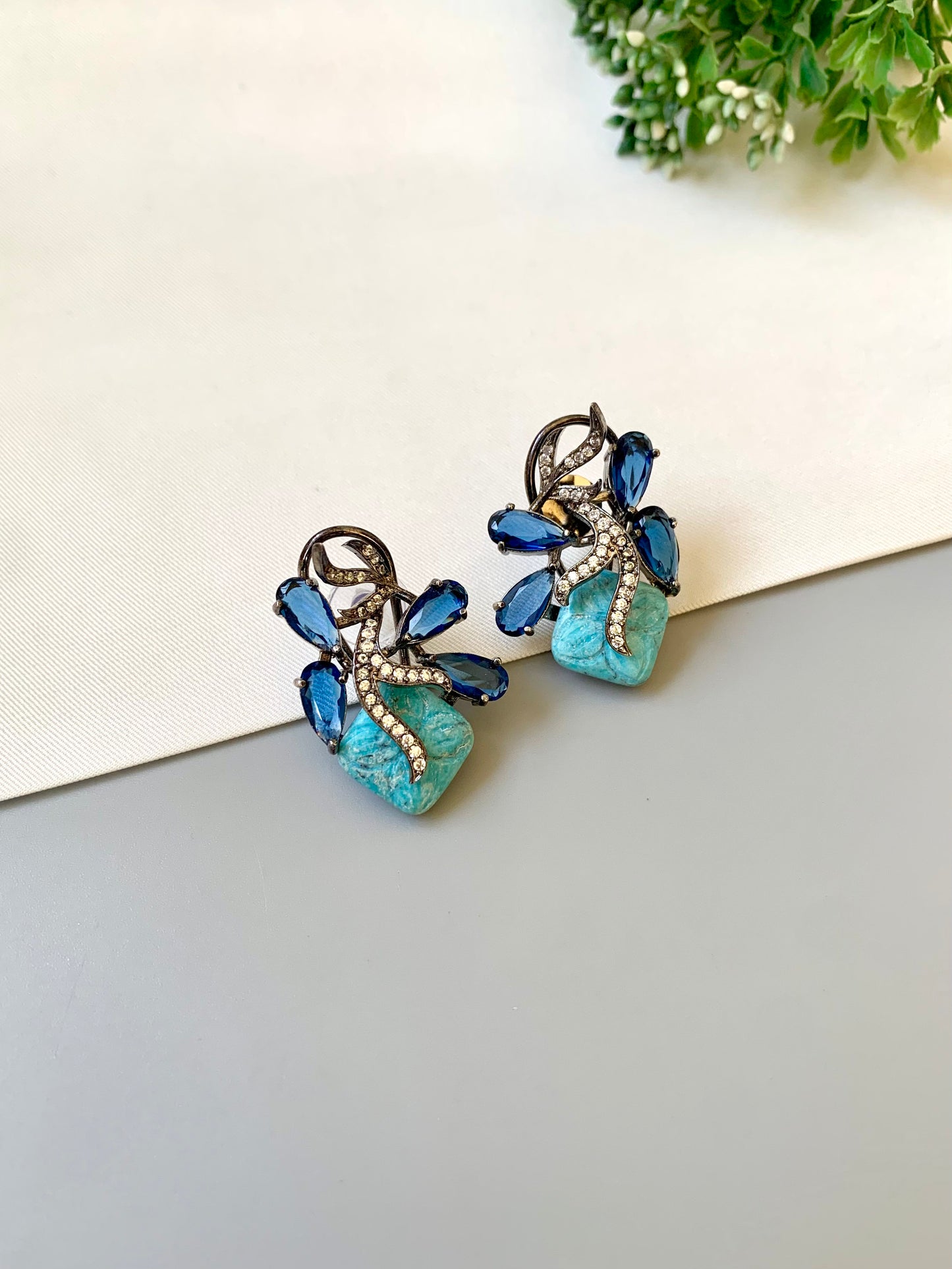 Hand crafted Zita Feroza studs in rhodium plating with oxidized polish, featuring American Diamonds, hand carved Feroza and Sapphire stones