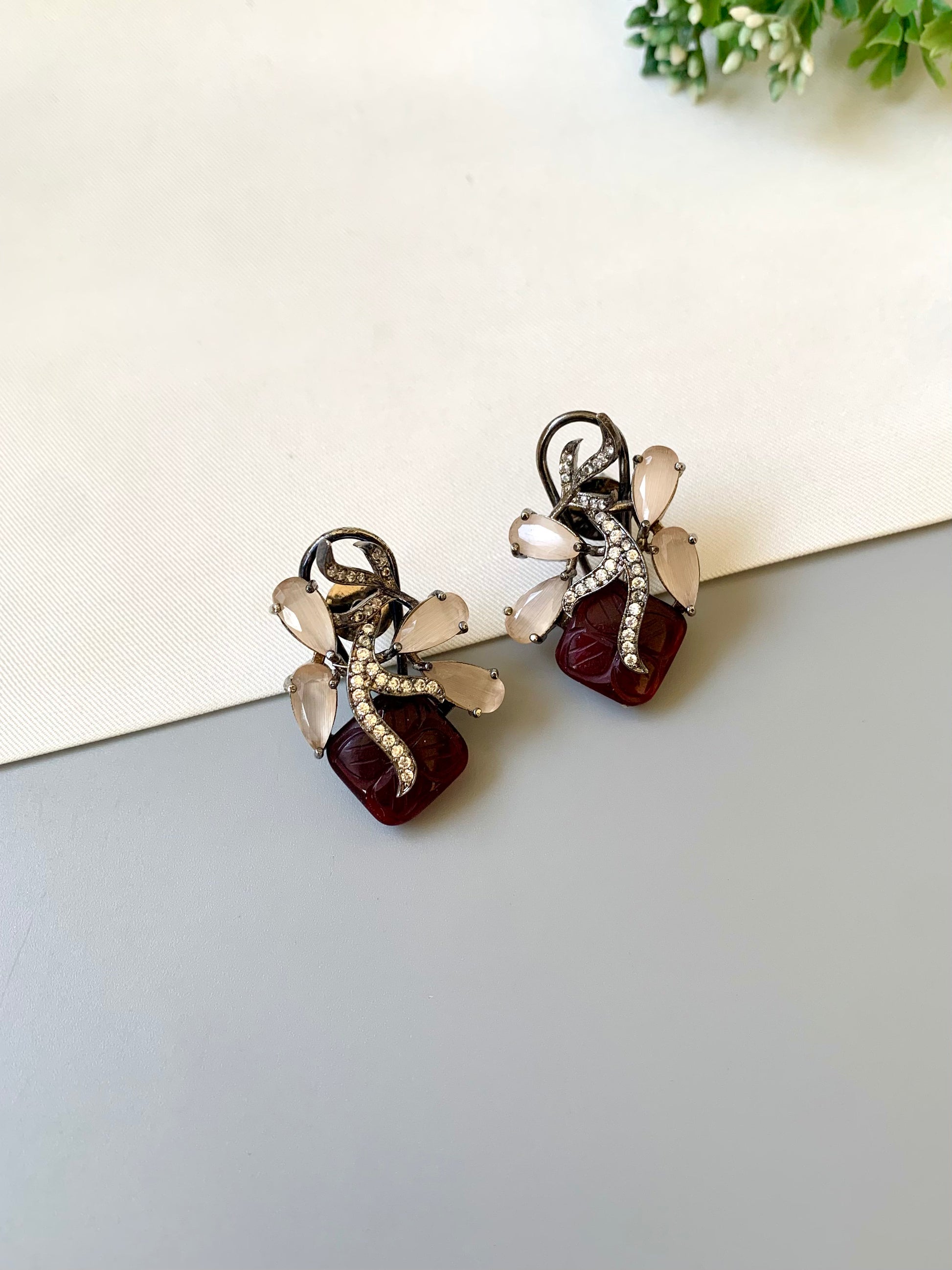 Hand crafted Zita Ruby studs in rhodium plating with oxidized polish, featuring American Diamonds, hand carved Ruby and Onyx stones