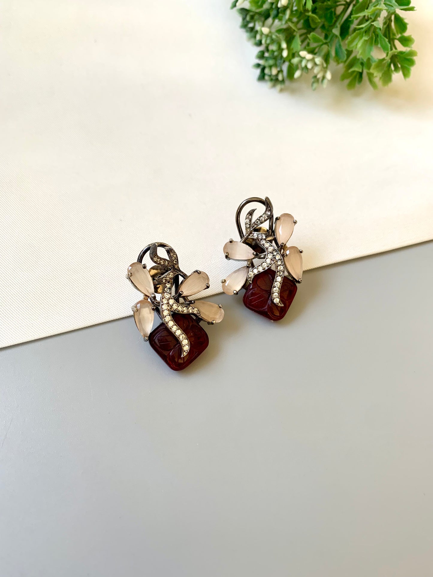 Hand crafted Zita Ruby studs in rhodium plating with oxidized polish, featuring American Diamonds, hand carved Ruby and Onyx stones