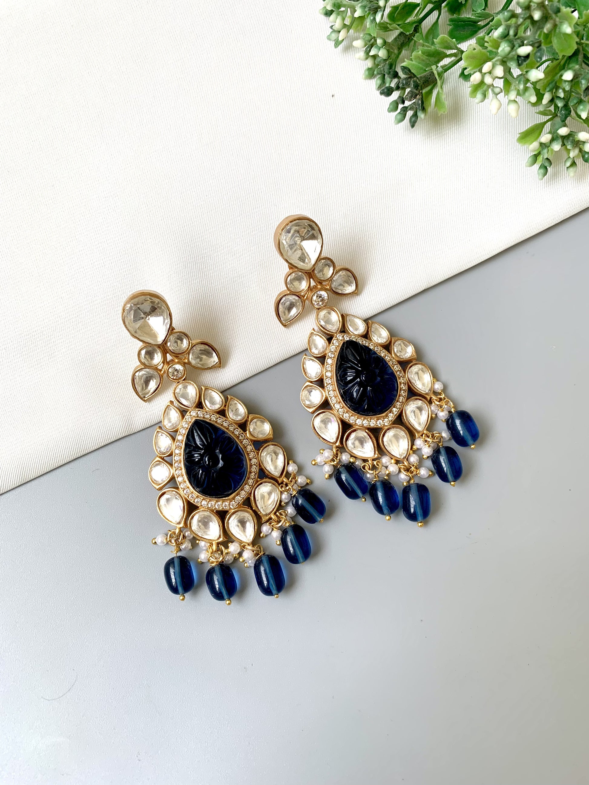 Zoya Signature Danglers with carved sapphire center, surrounded by Moissanite Kundan and American Diamonds in teardrop shape