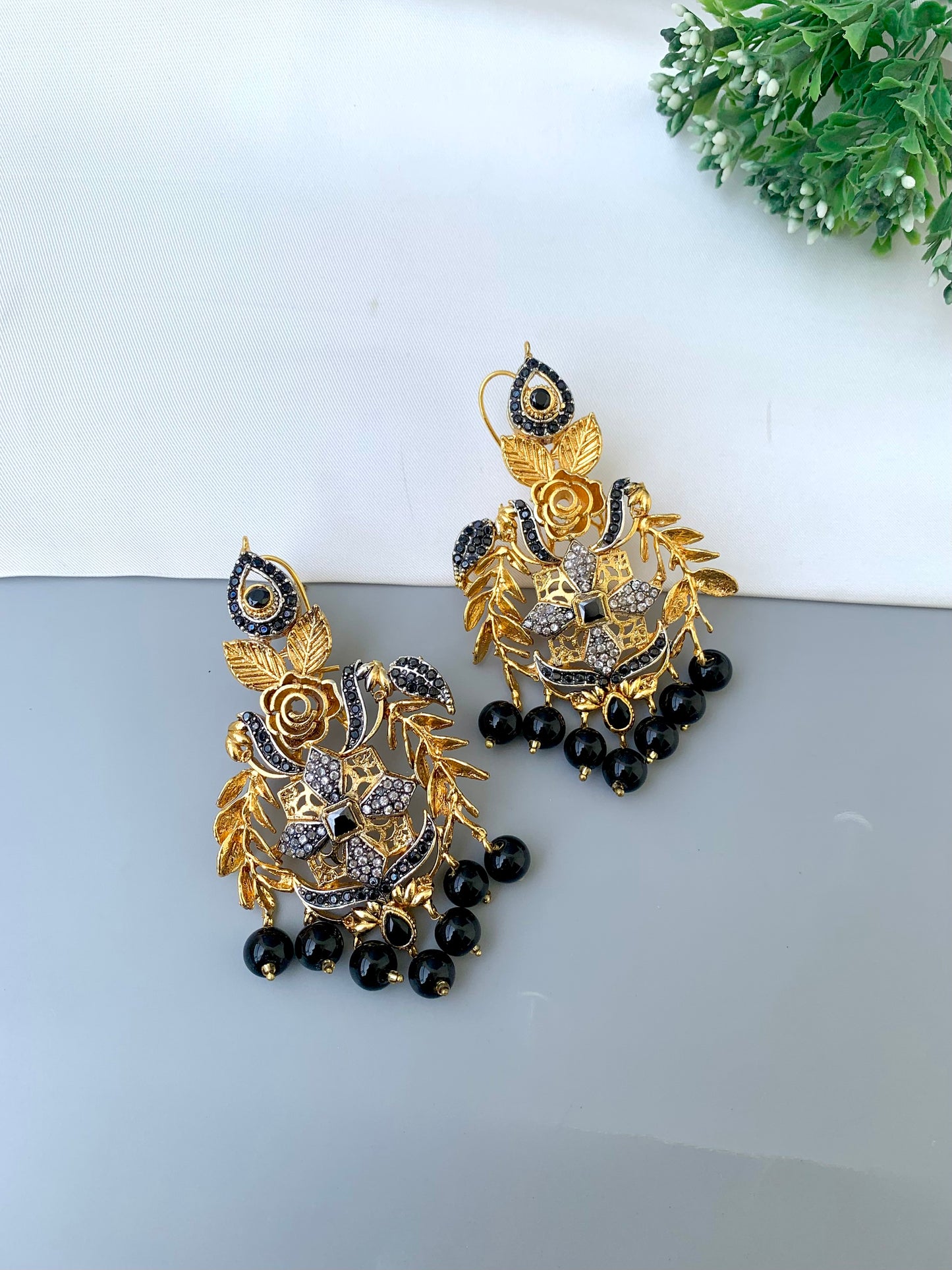 Zulehka black onyx earrings in gold plating with American diamonds