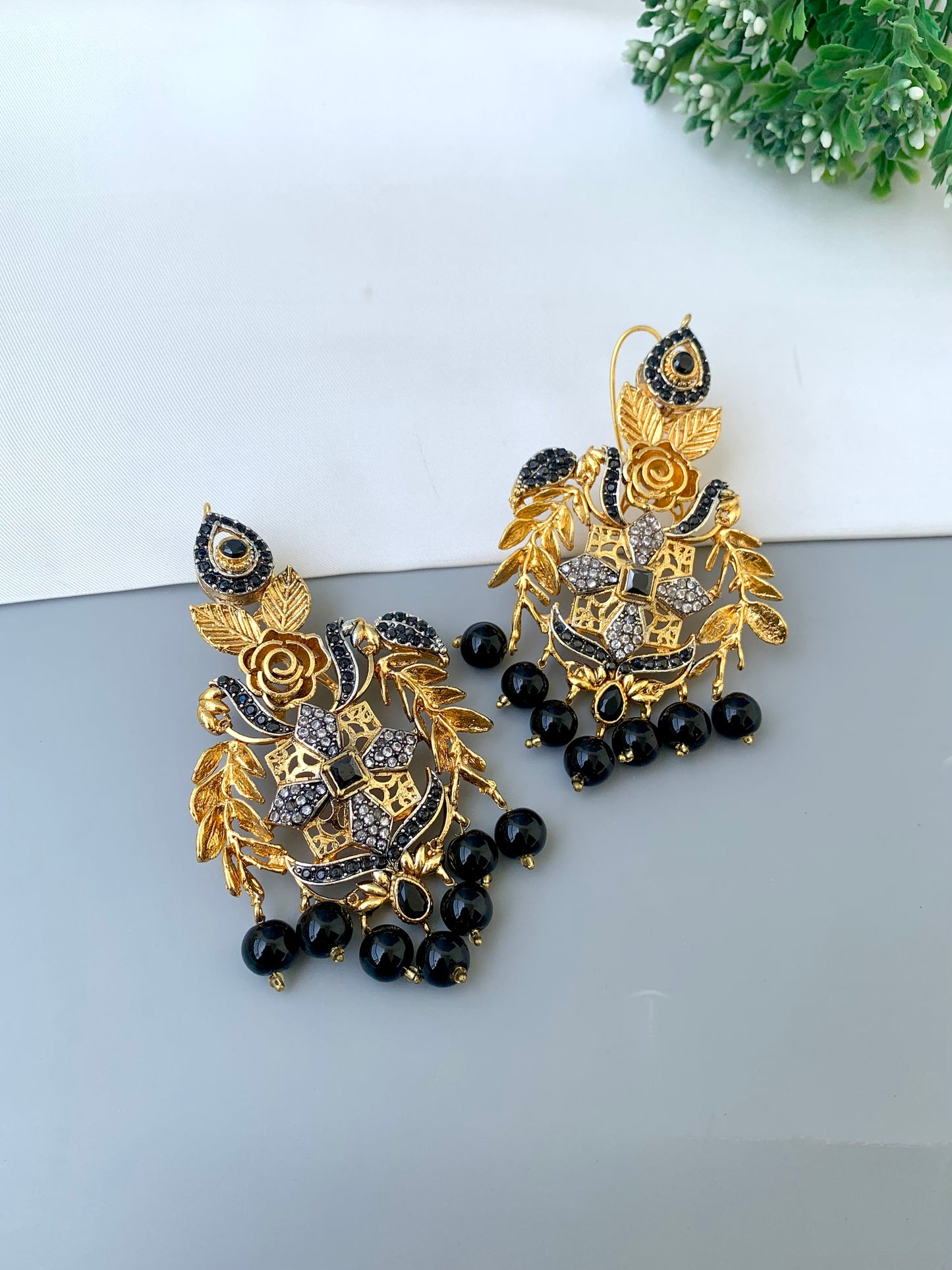 Zulehka black onyx earrings in gold plating with American diamonds