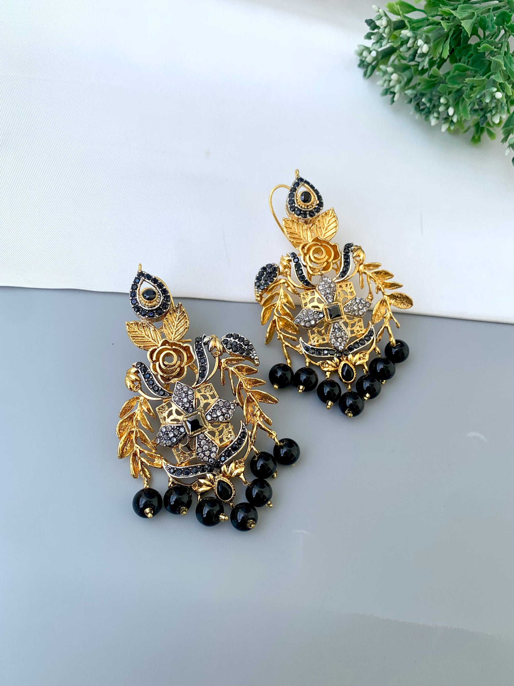 Zulehka black onyx earrings in gold plating with American diamonds