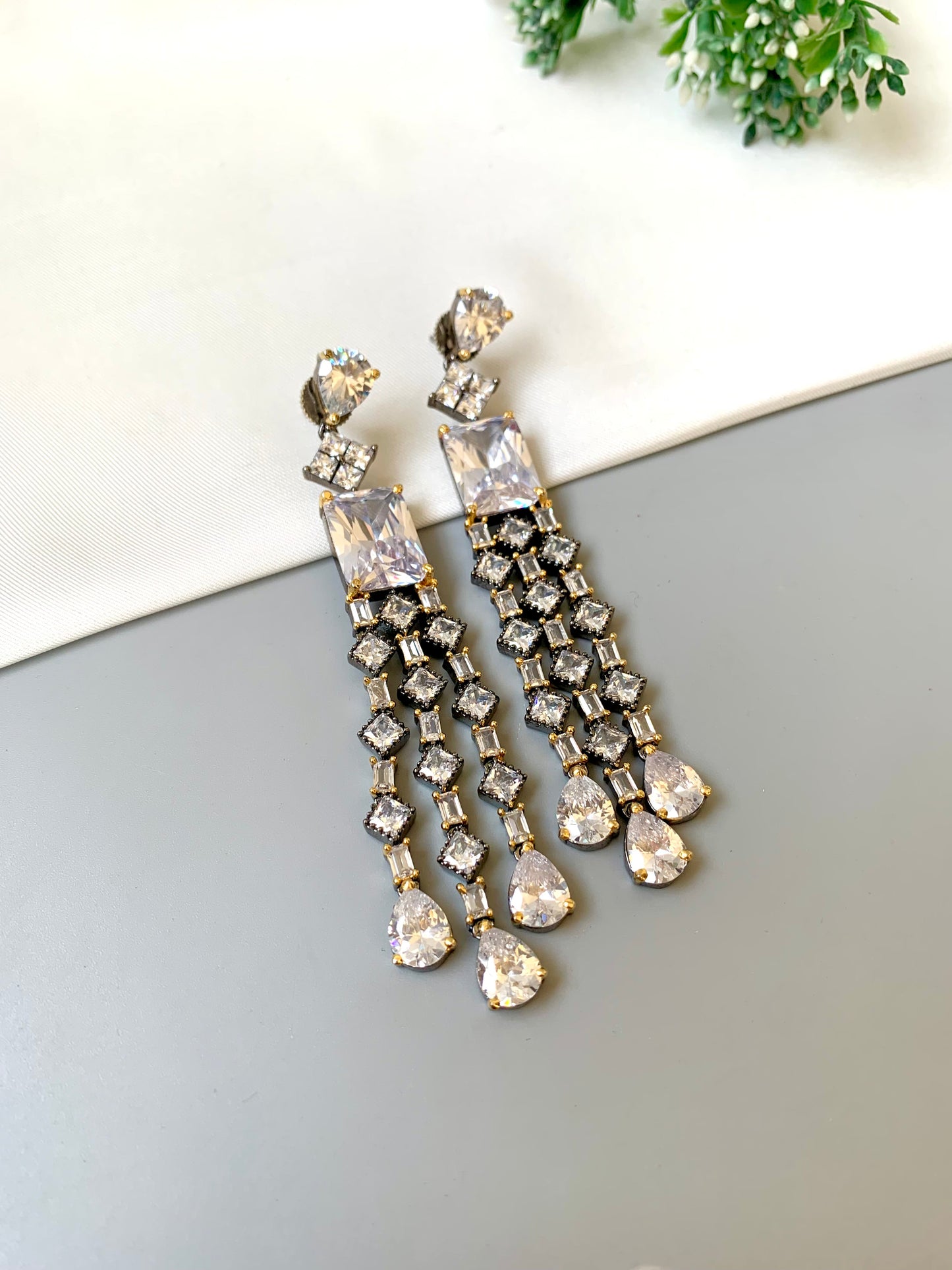 Zunair handcrafted signature earrings in gold and rhodium plating with black oxidized finish and American diamonds