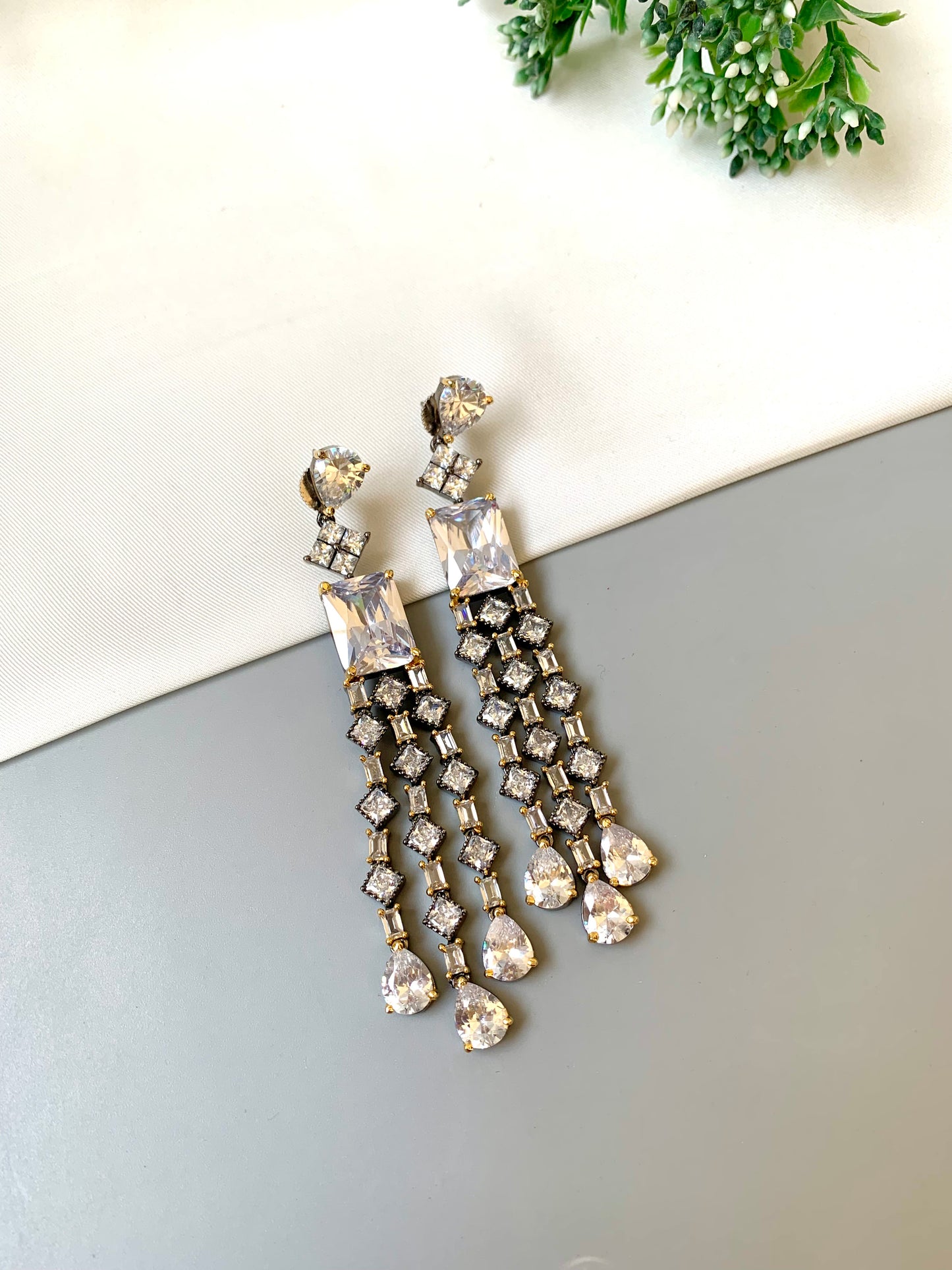 Zunair handcrafted signature earrings in gold and rhodium plating with black oxidized finish and American diamonds